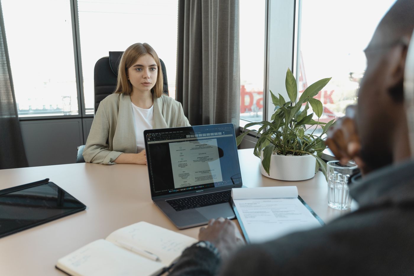 Candidate in a job interview with a hiring manager at a laptop