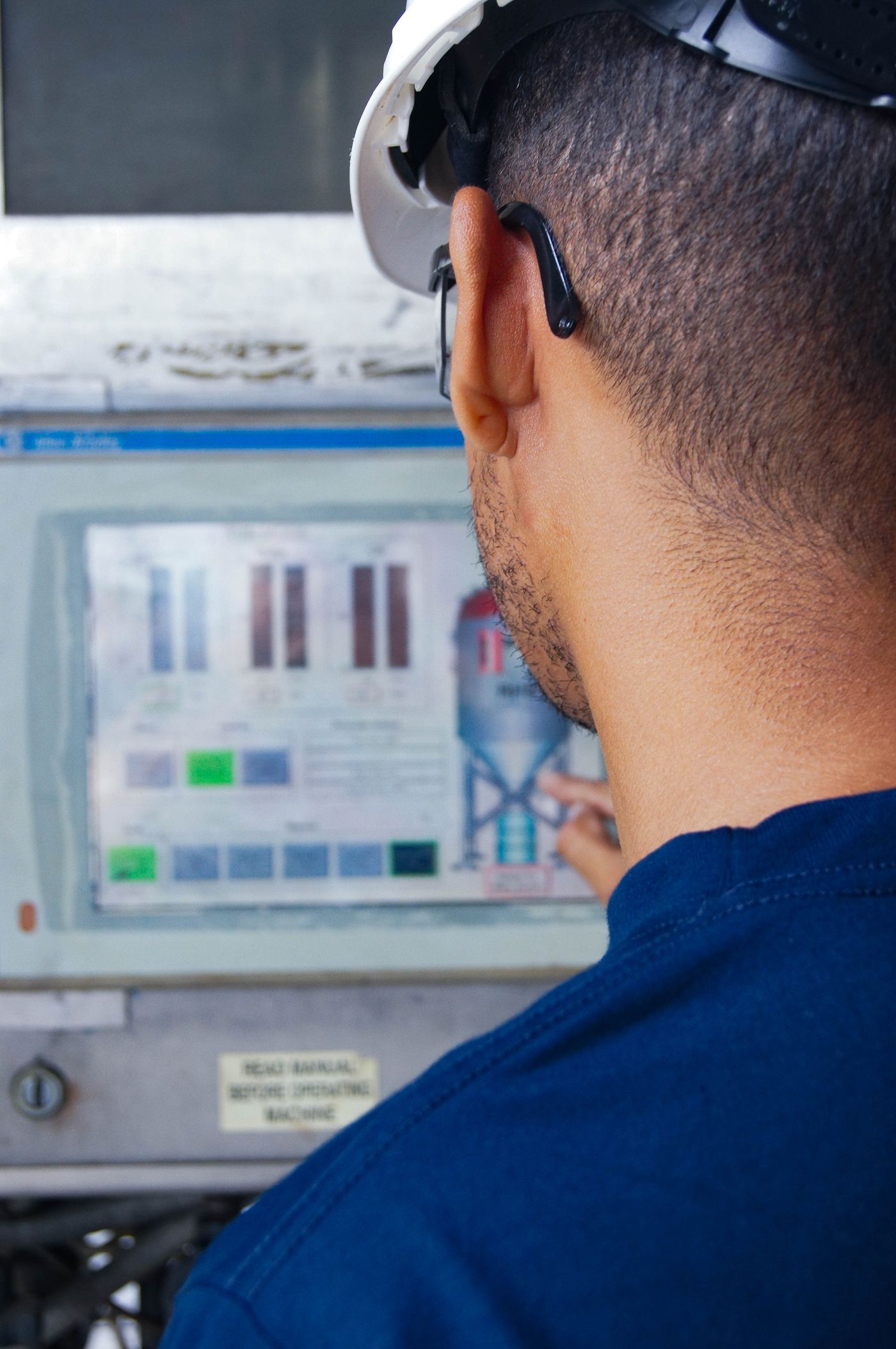 Operator checking a machine control screen