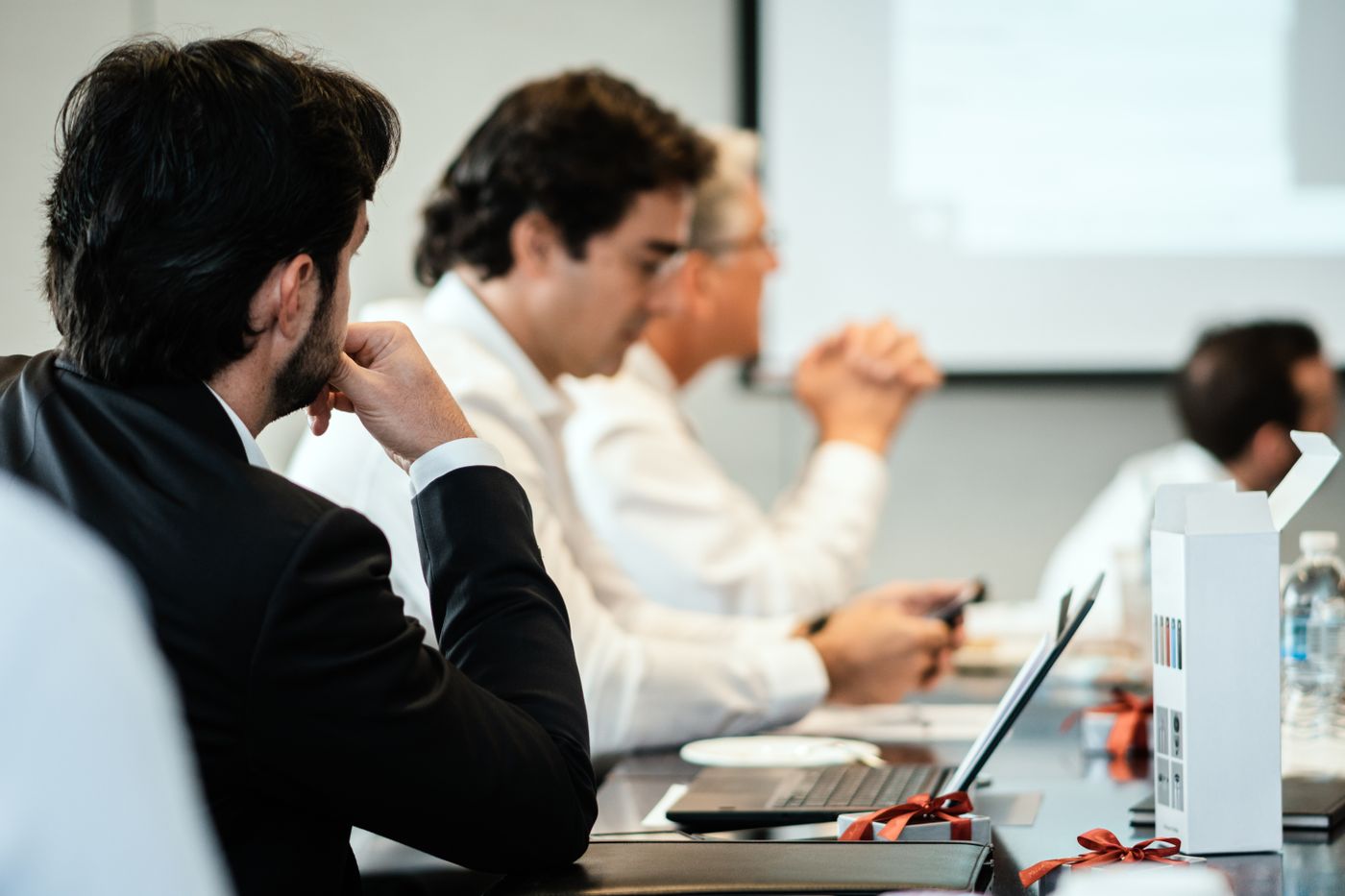 Leaders listening during a meeting around a conference table