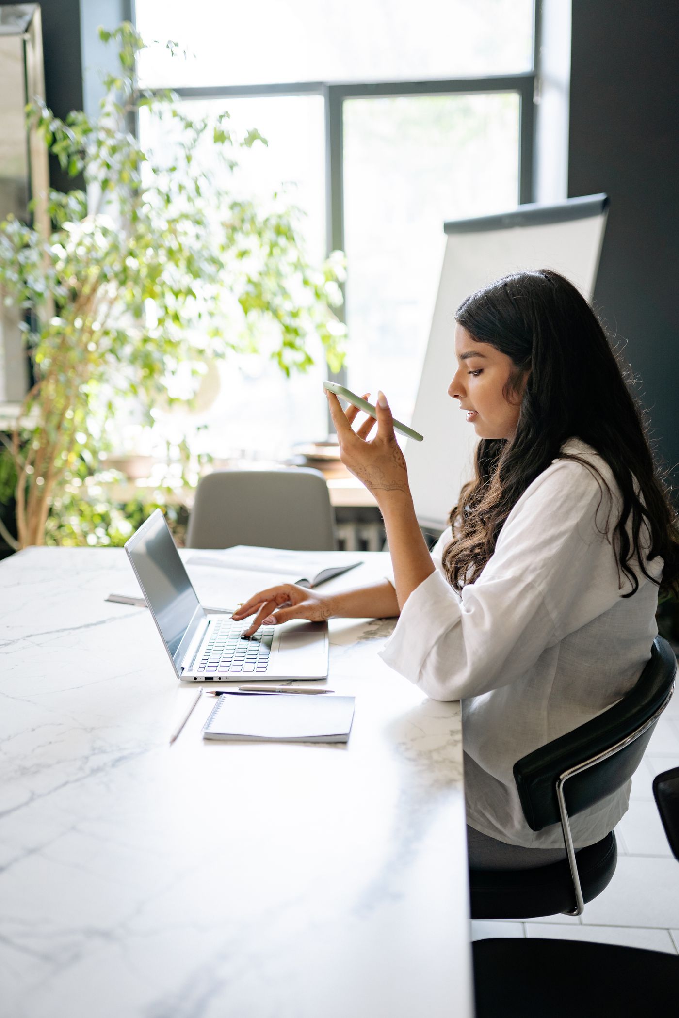 Professional working at a laptop in a bright modern office