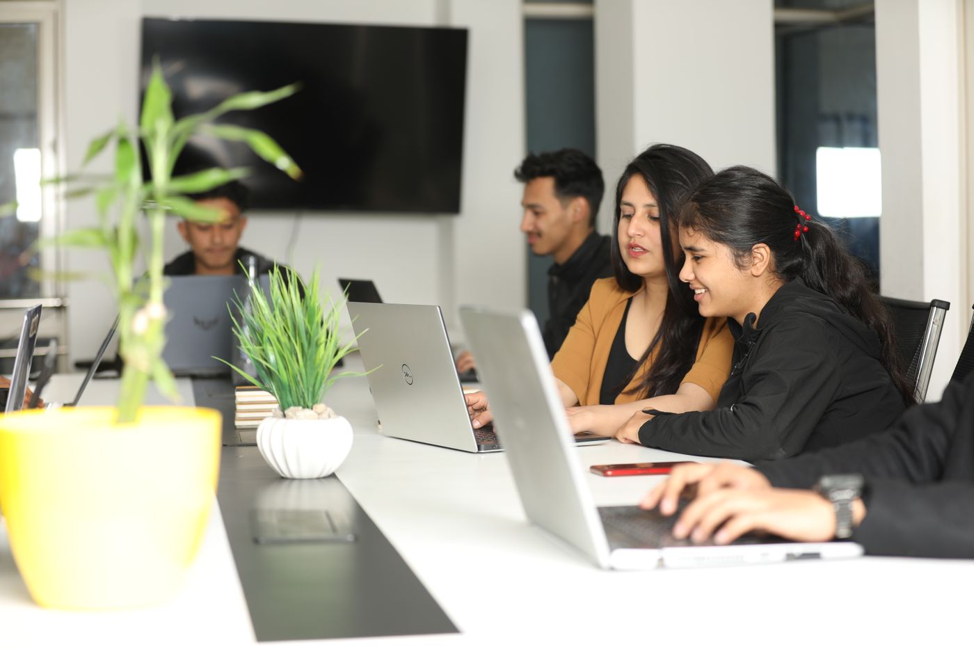 Colleagues working together at laptops in a coworking space