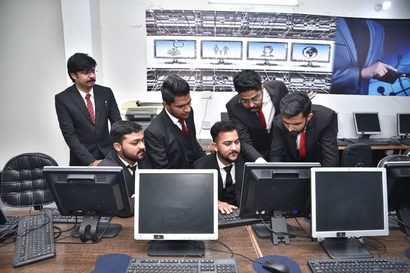 India GCC technology team gathered around workstations in an engineering office