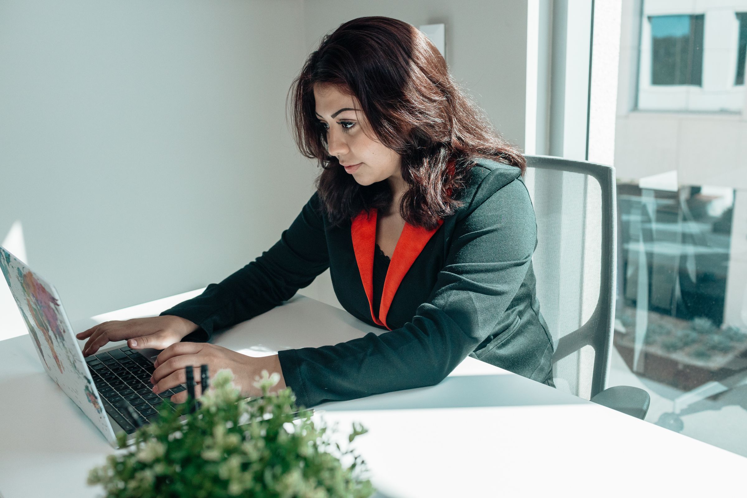 Professional working on a laptop in a bright office