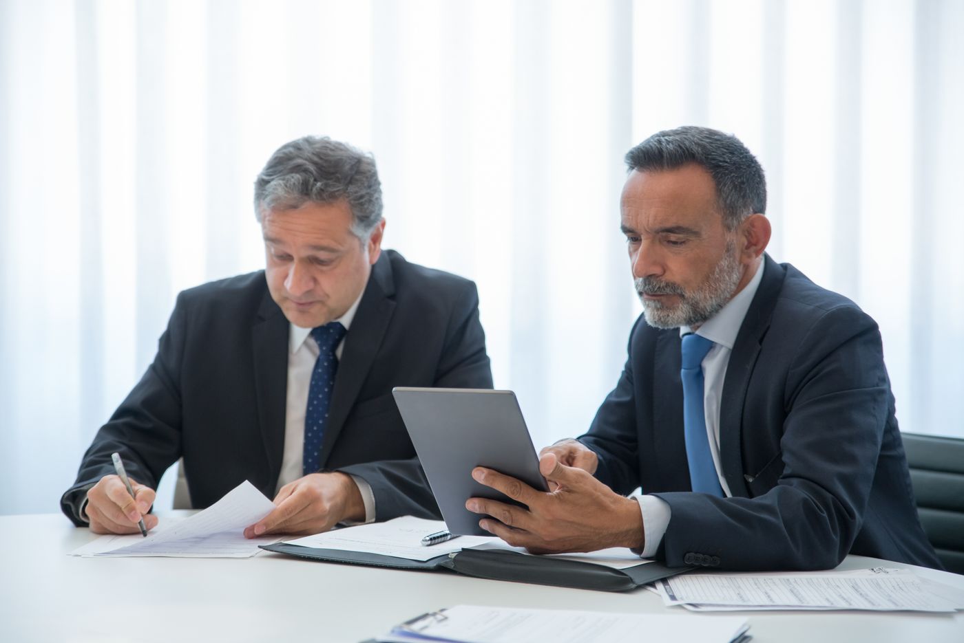 Managers approving a request on a tablet
