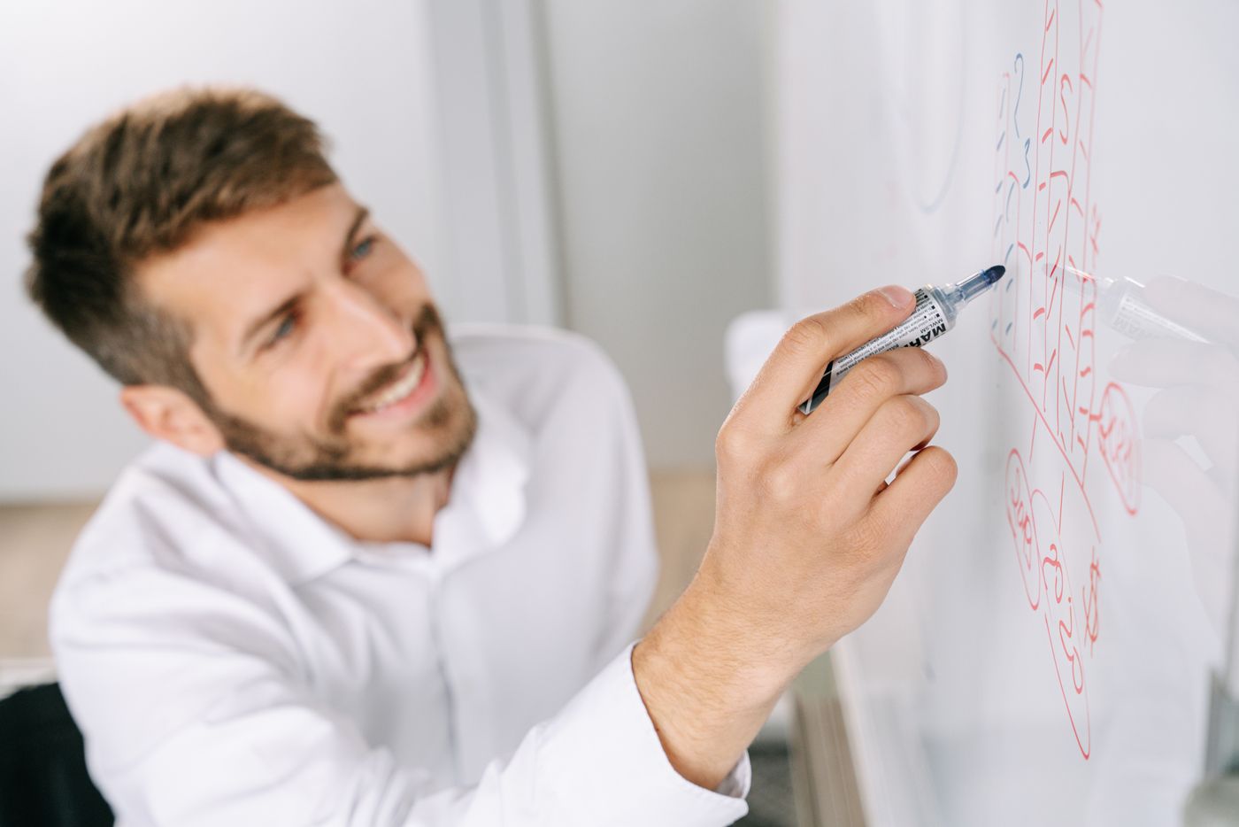 Engineer planning the production architecture on a whiteboard