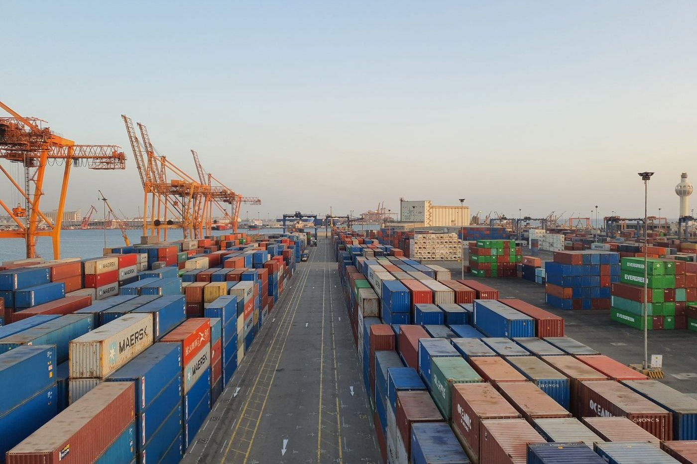Aerial view of shipping containers stacked at a busy freight terminal