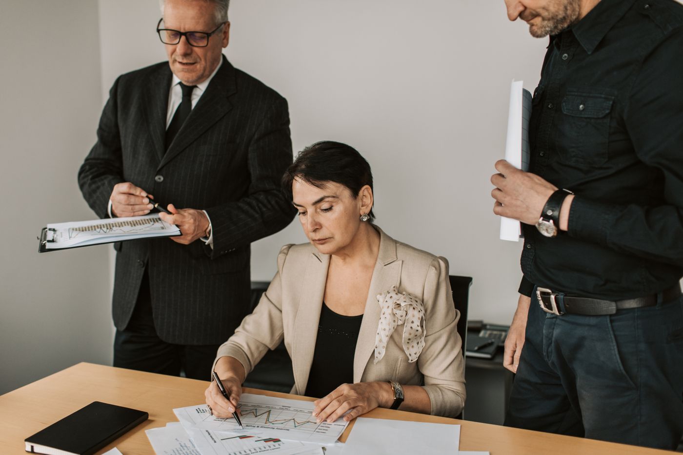 Leaders reviewing decision documents together at a table