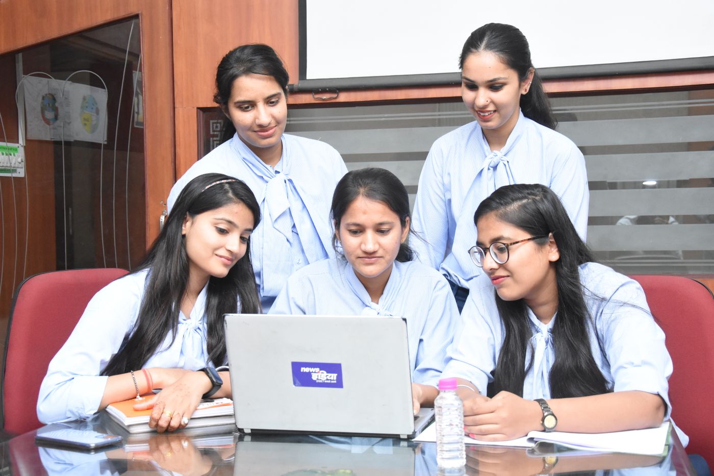 Marketing team developing a campaign around a laptop