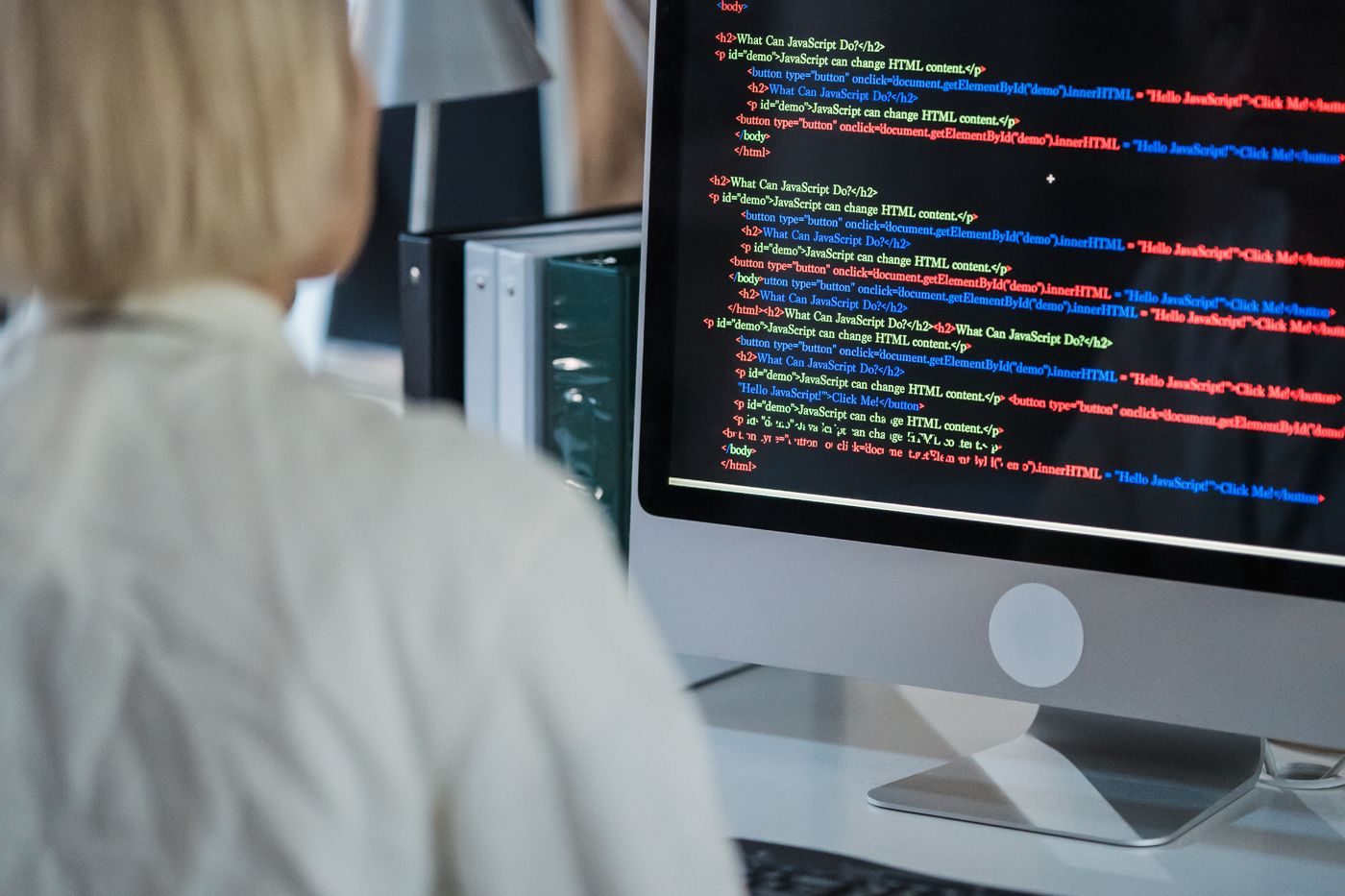 Engineer reviewing code on a desktop monitor