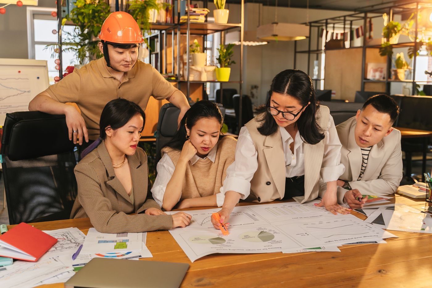 Operations team reviewing integration plans together around a table