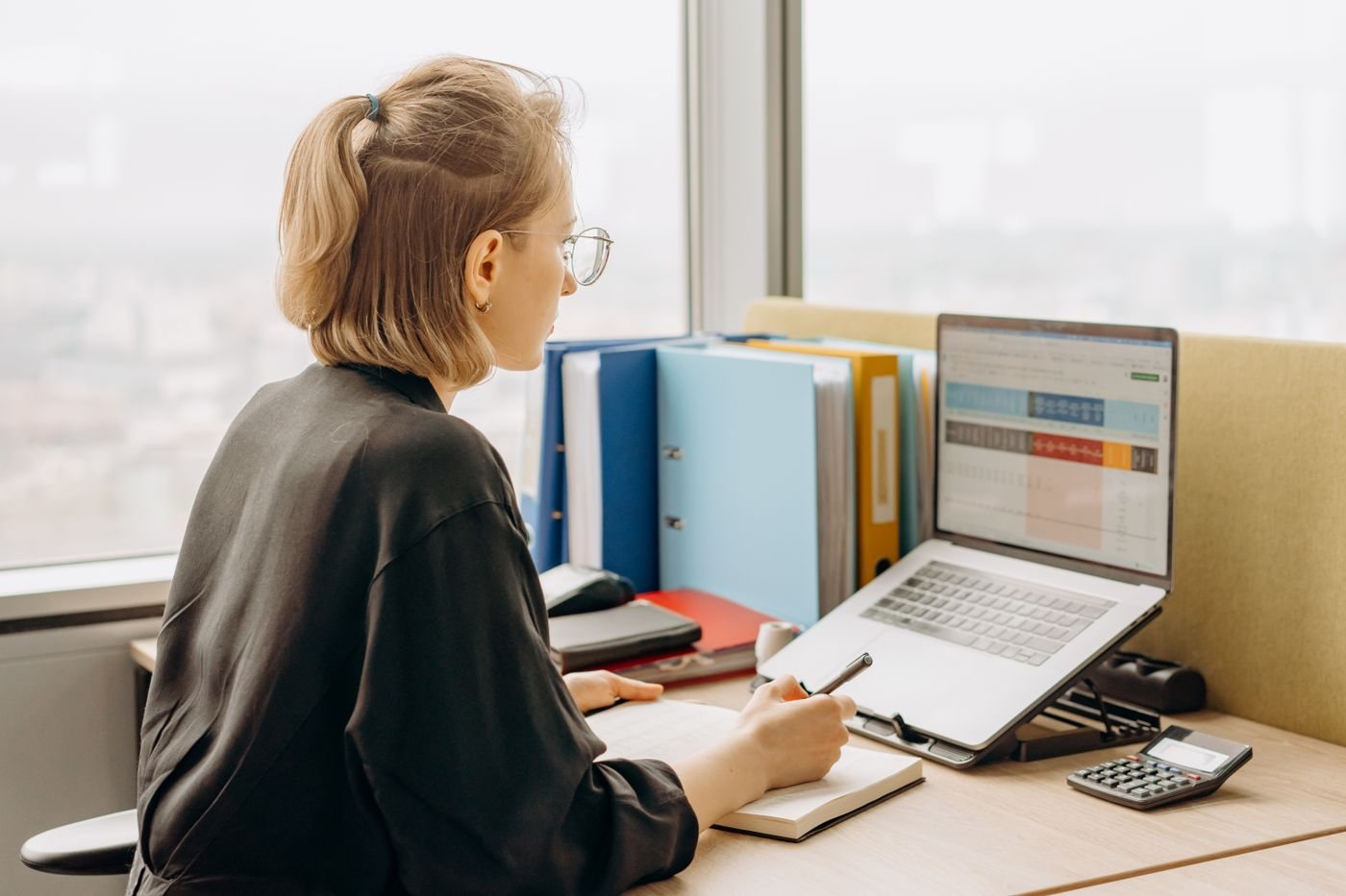 Sales development rep researching contacts within target accounts on a laptop