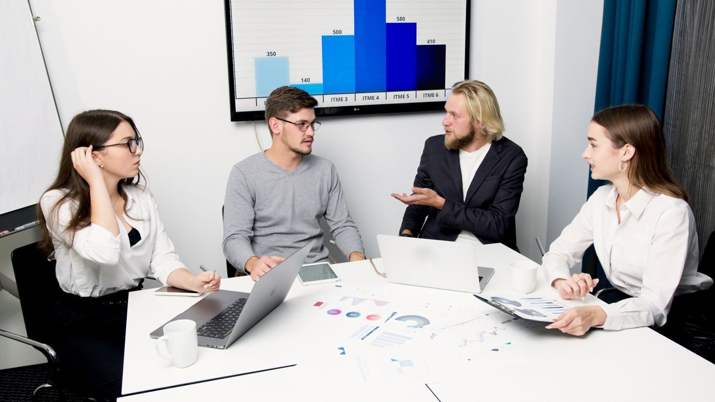 Revenue team discussing CRM reporting in a meeting room