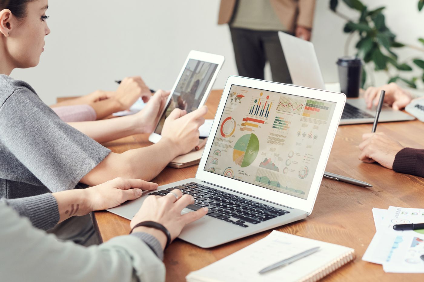 Coworkers analyzing CRM charts on their laptops