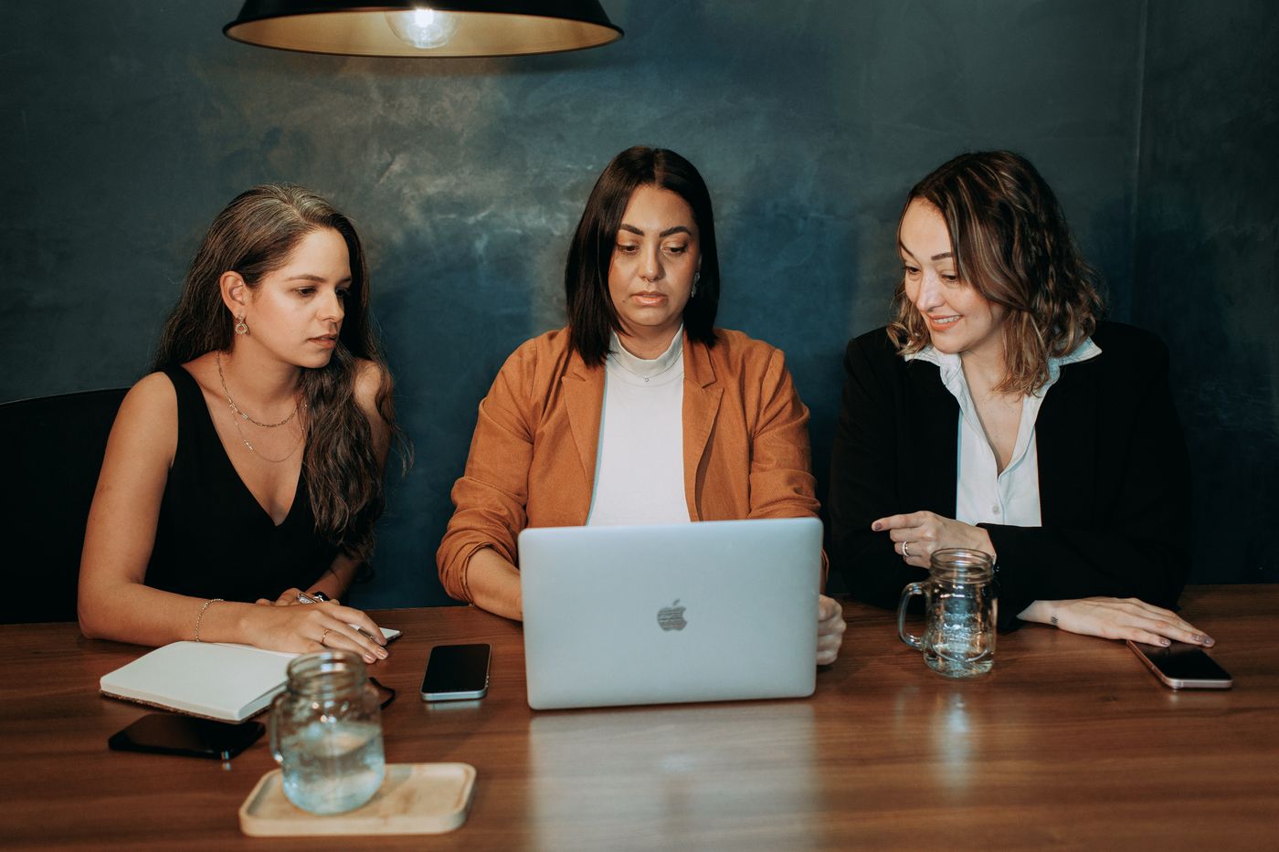 Three colleagues working through a cross-platform workflow