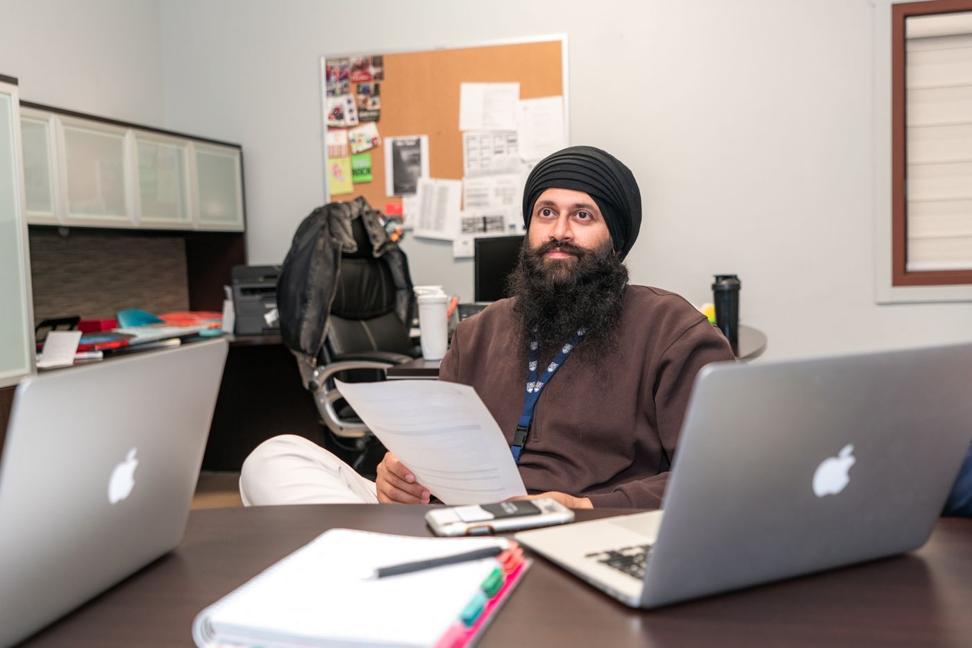 Operations lead reviewing enriched prospect data at his laptop
