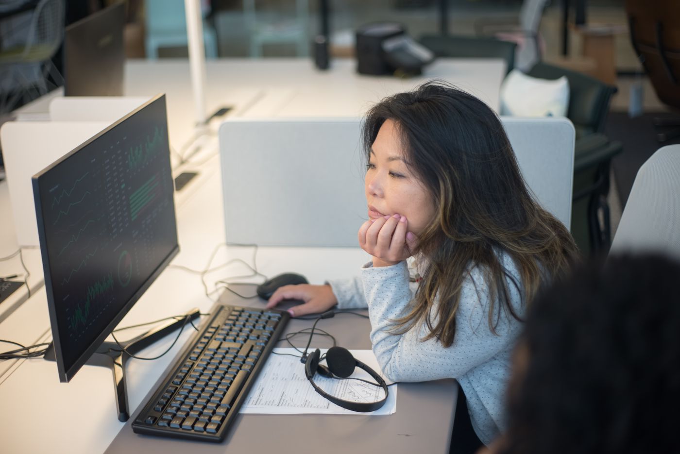Professional reviewing workflow data on a monitor
