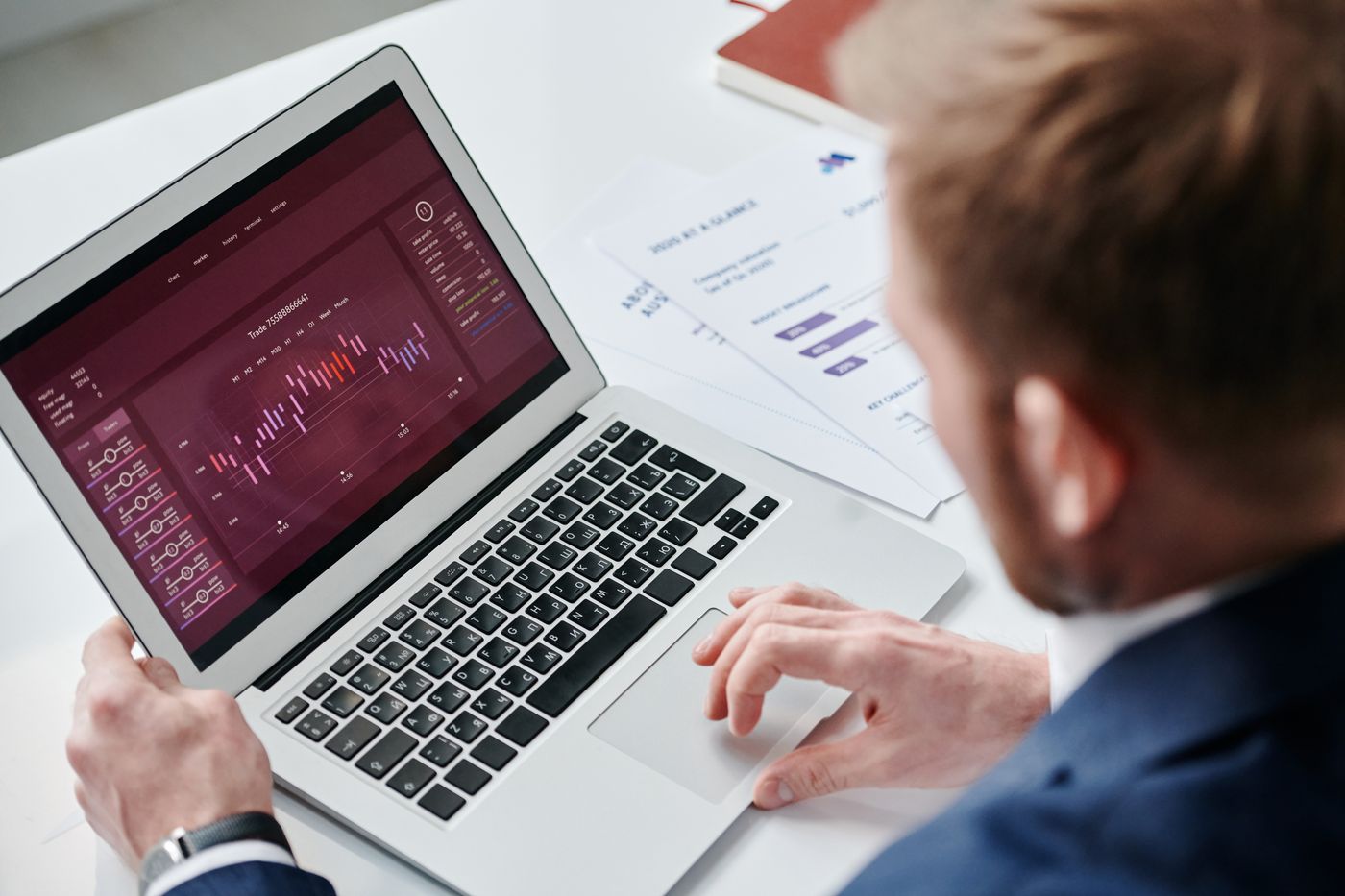 Professional reviewing a demand dashboard on a laptop