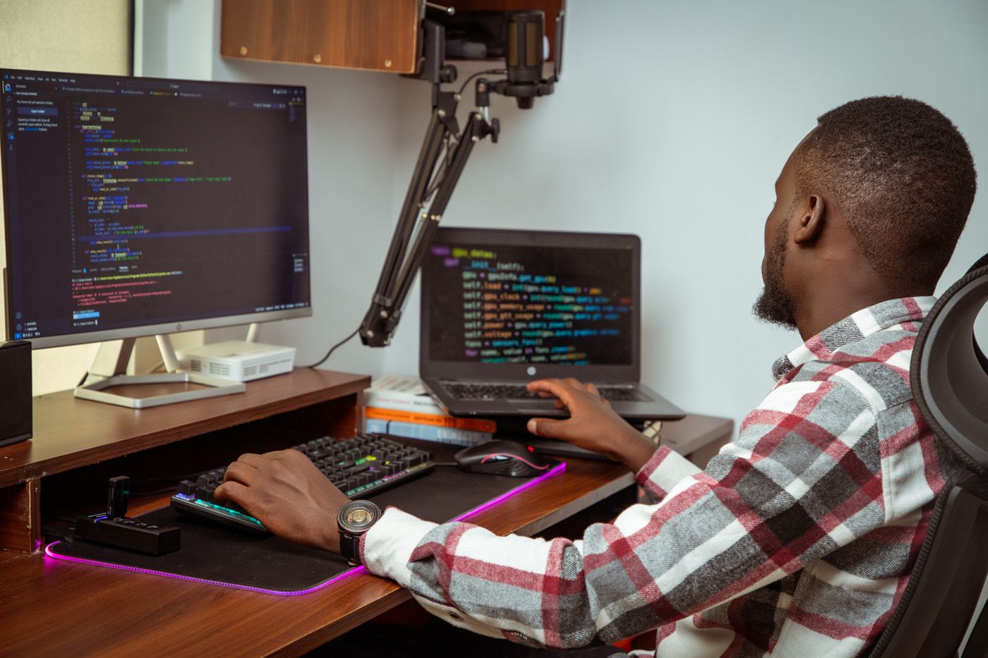 Developer configuring an application across a monitor and a laptop