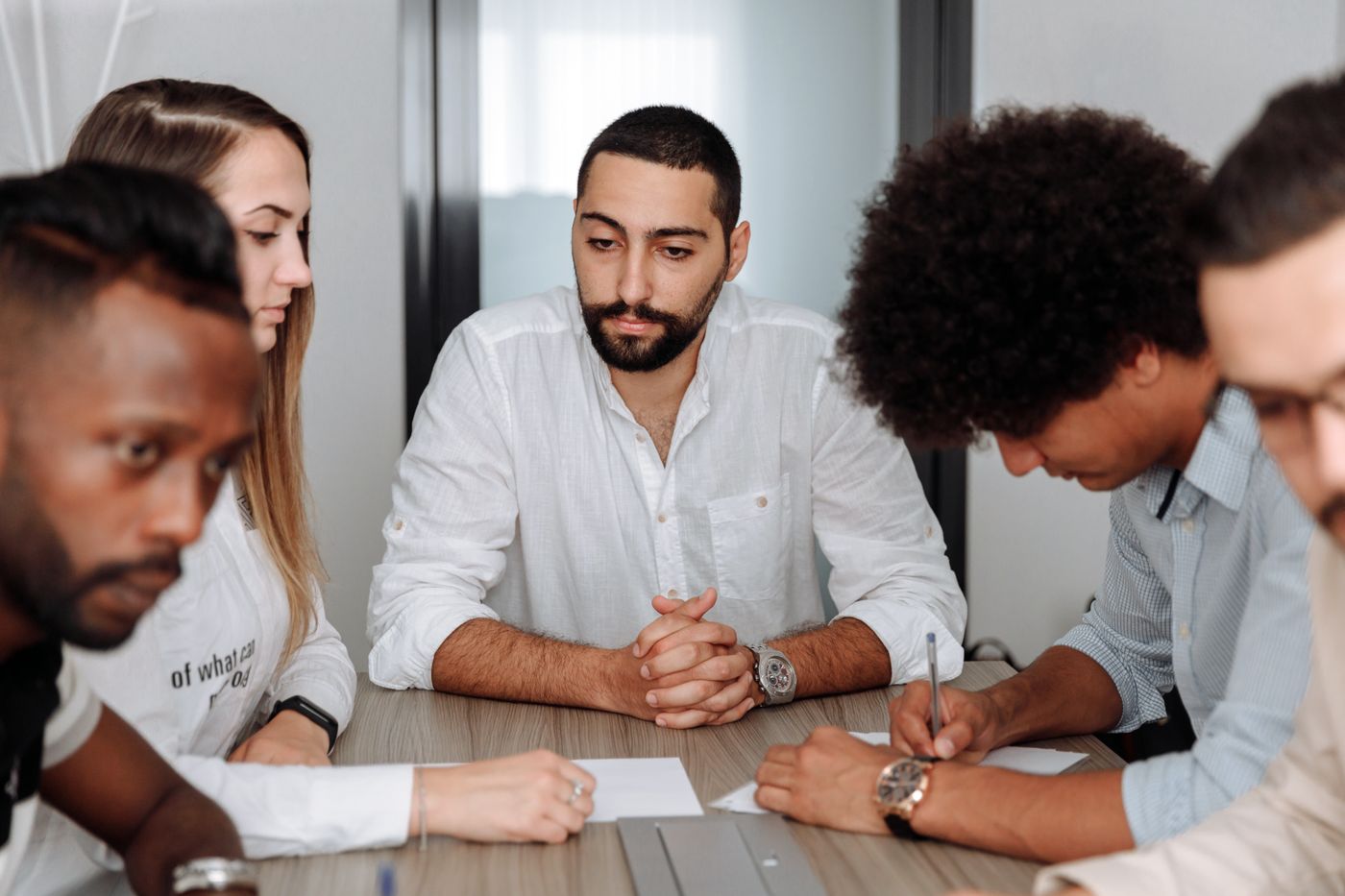 Employees sharing their experience in an EVP research discussion around a table