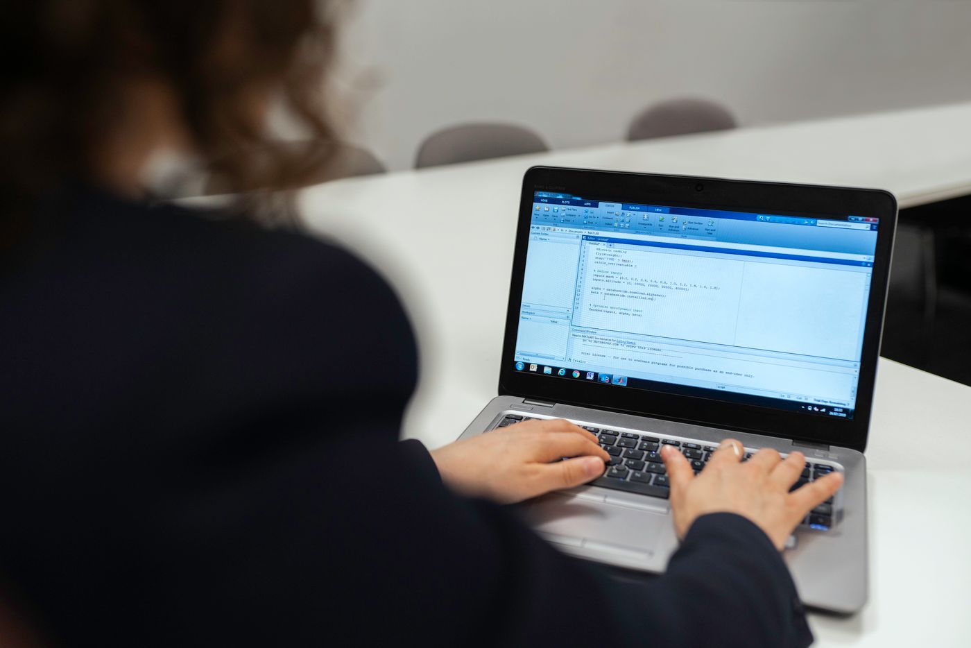 Tester validating an application on a laptop