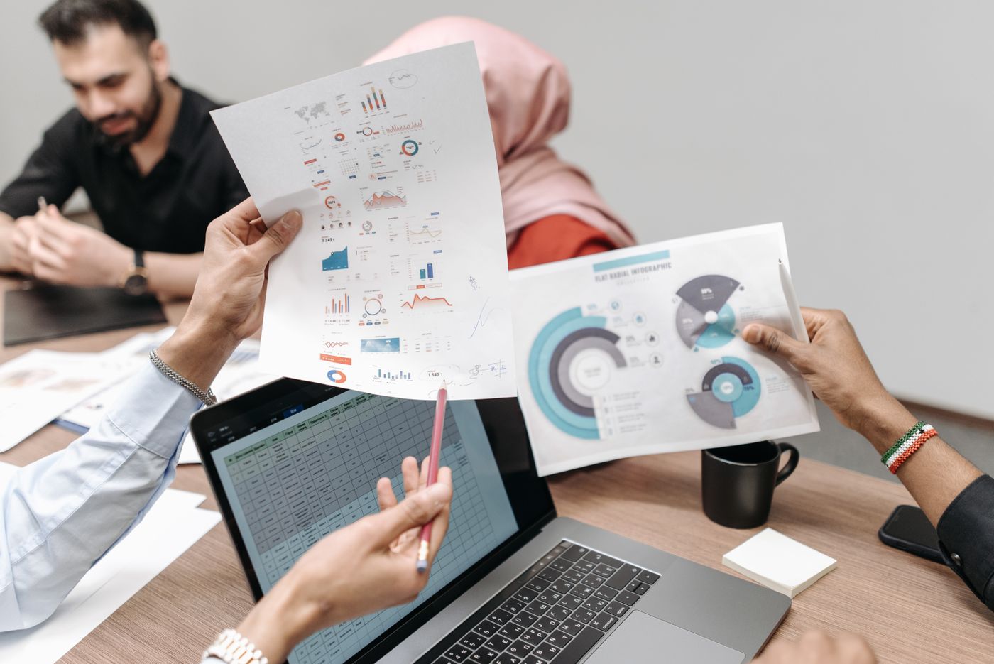 Team reviewing funnel reports beside a laptop