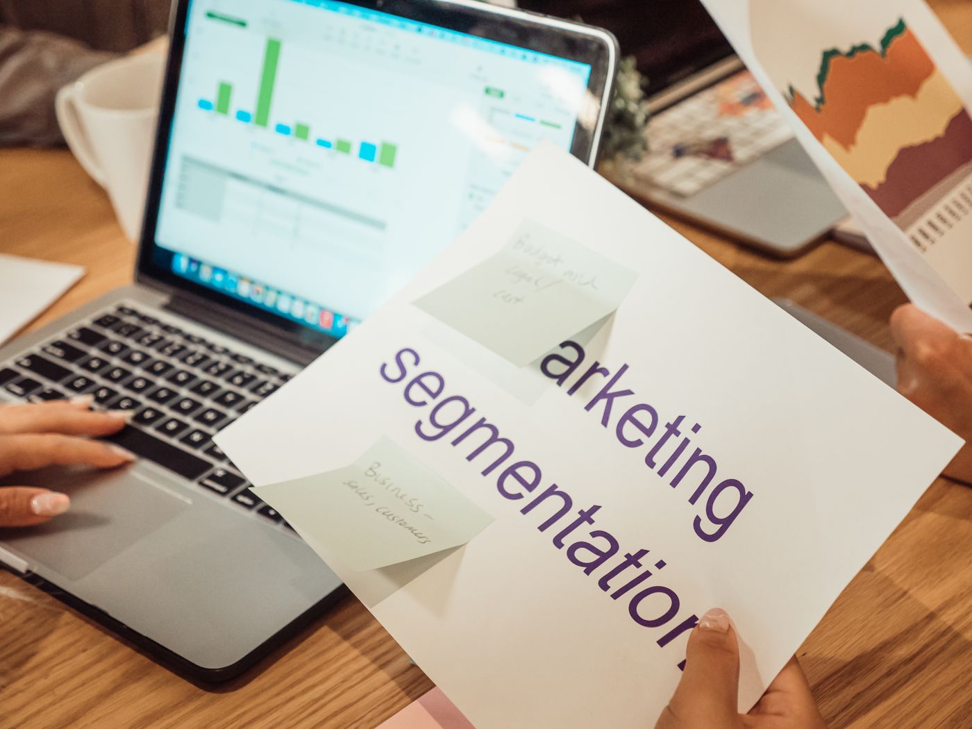 Marketer reviewing audience segmentation beside a laptop