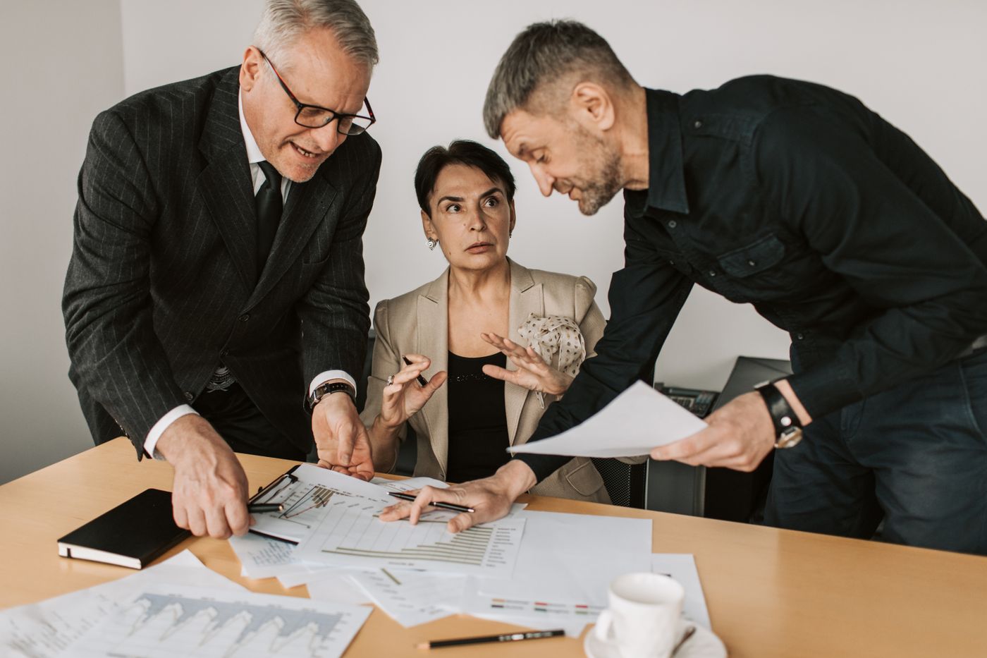 Three colleagues defining customer profiles over documents