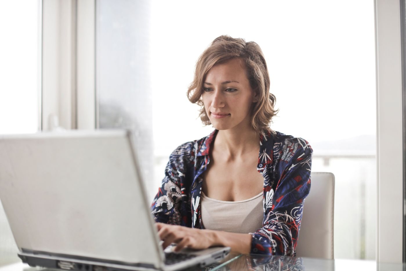 Engineer configuring an integration environment on a laptop in a bright office