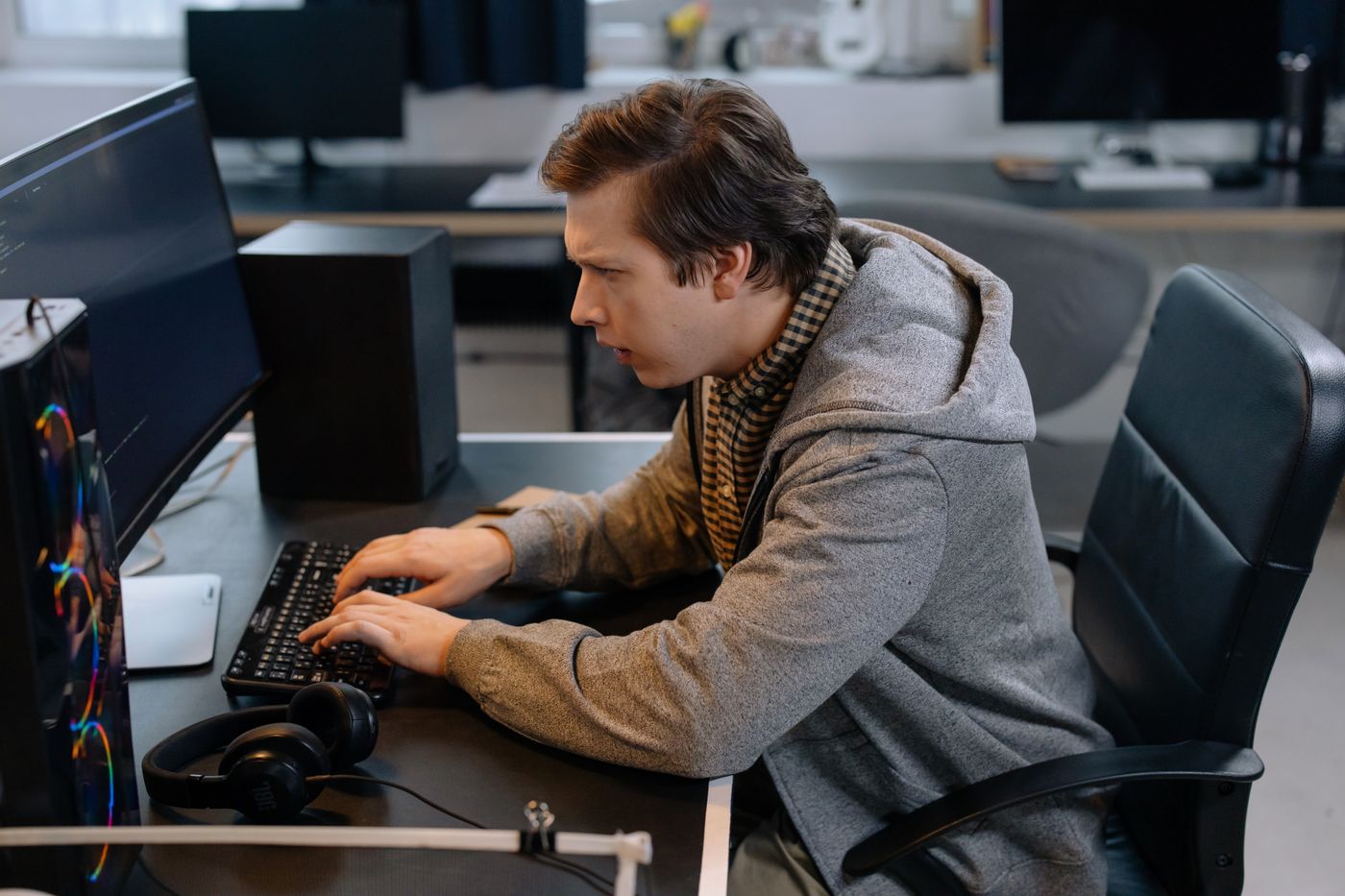 Engineer connecting systems at a multi-monitor workstation