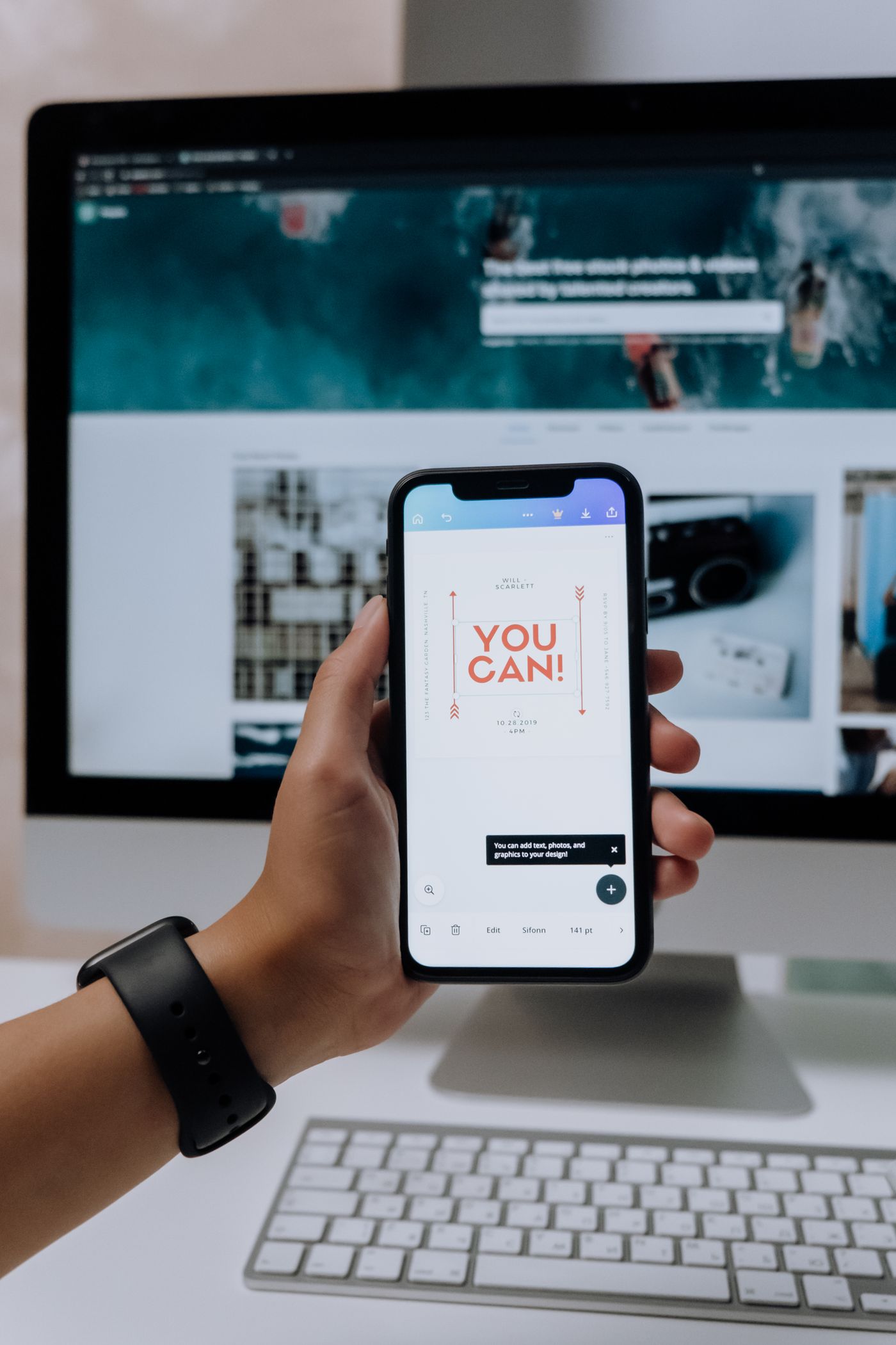 Phone showing a SaaS landing page in front of a desktop