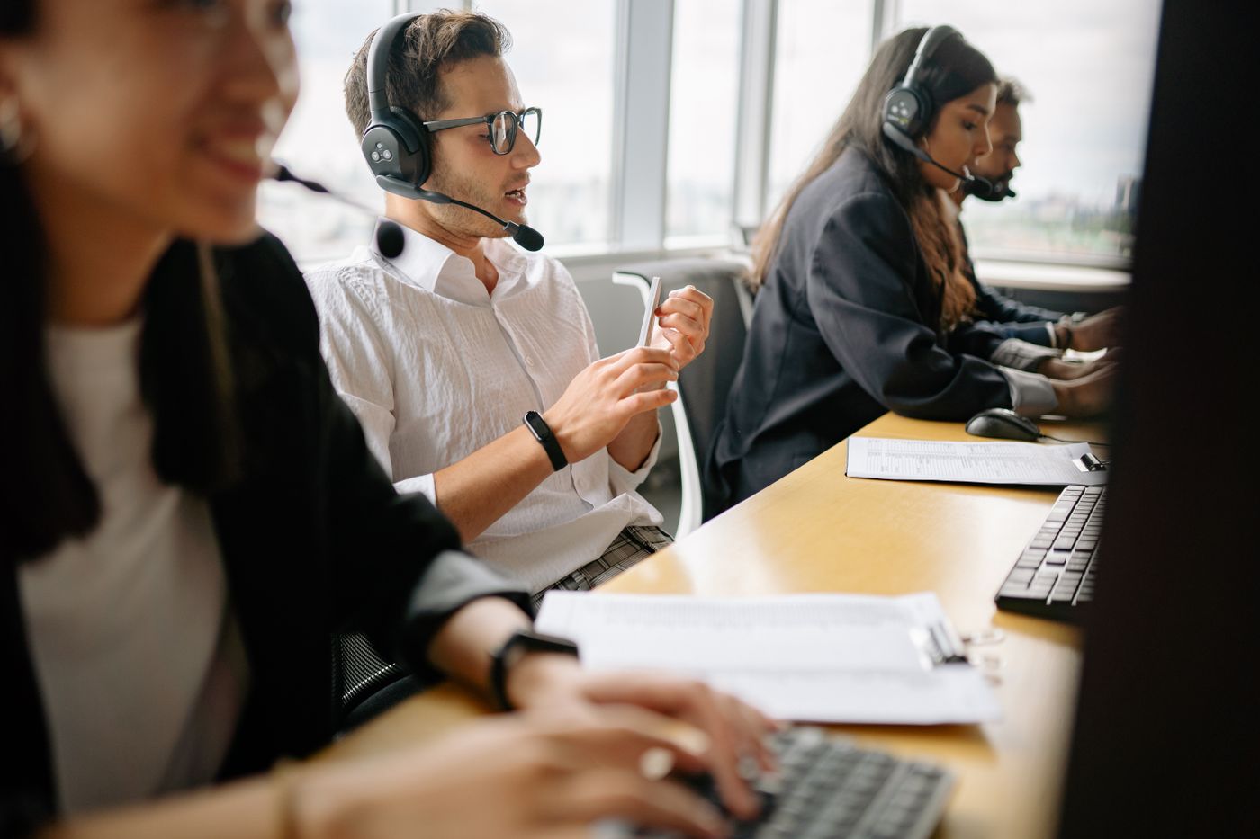 Support team with headsets working at their desks