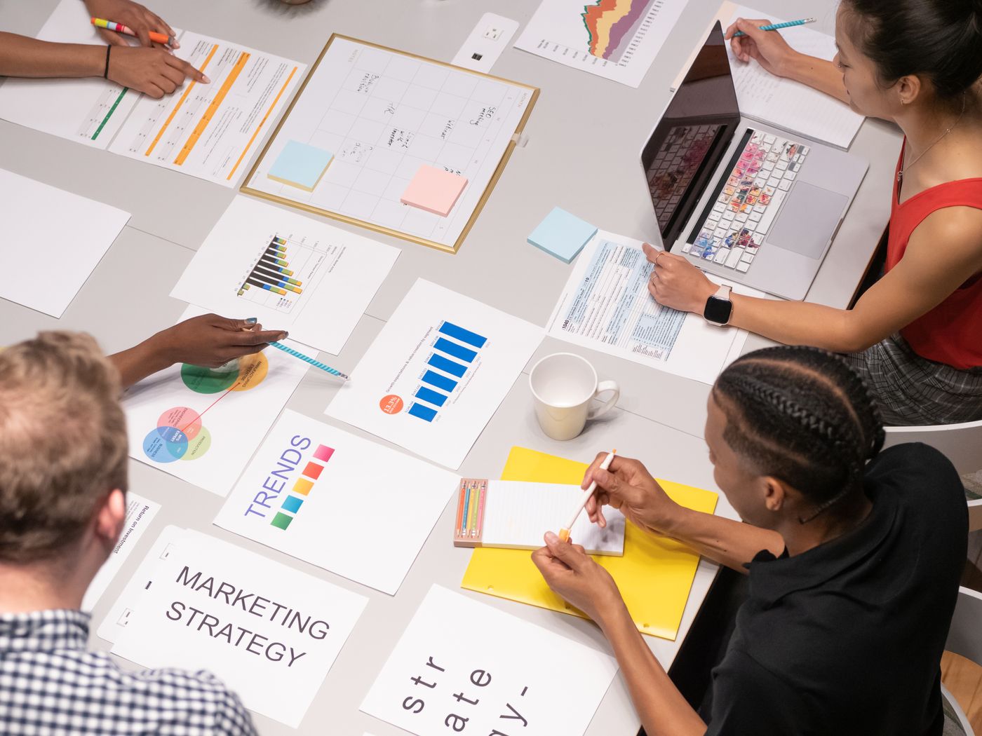 Marketing team laying out campaign data and charts