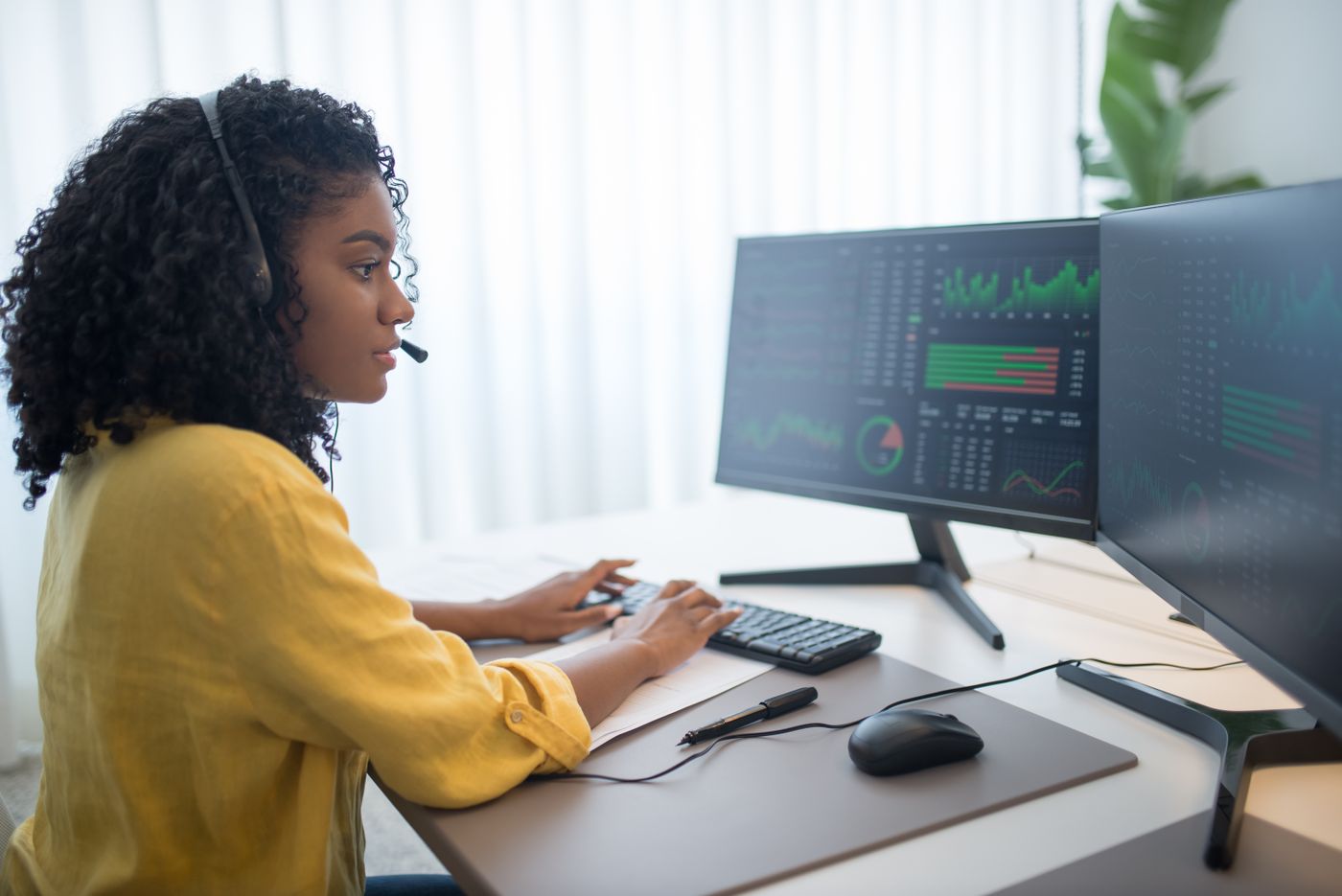 Analyst monitoring process dashboards across two screens