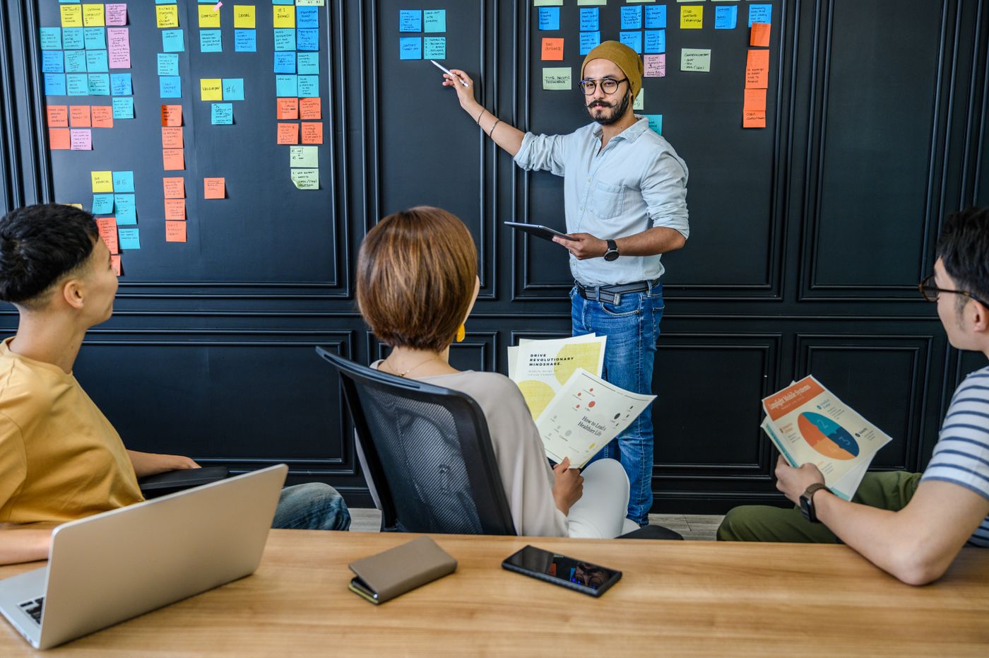 Product team reviewing requirements on a wall of sticky notes