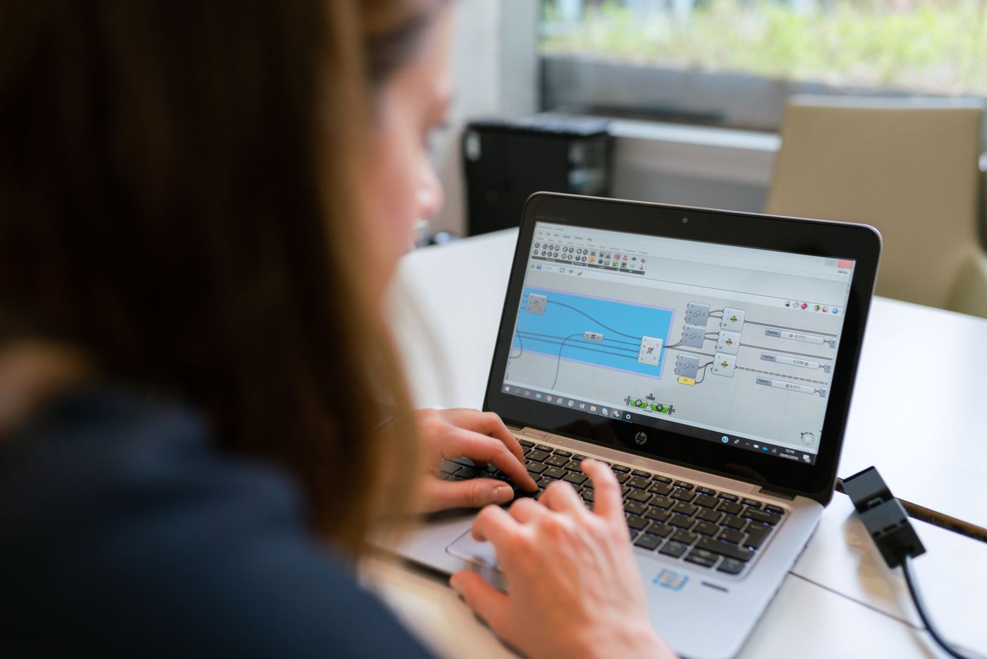 Engineer testing a product build on a laptop