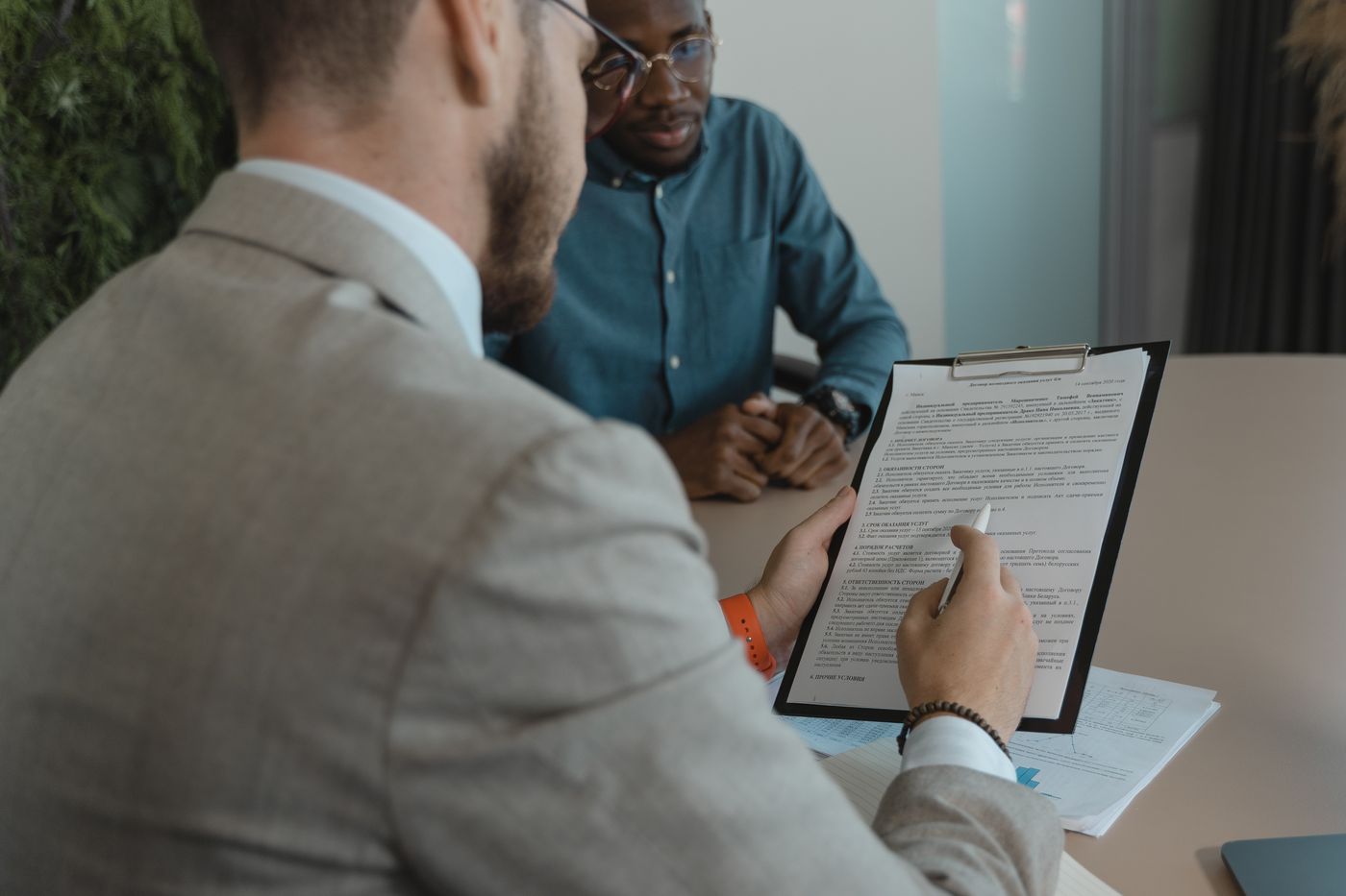 Recruiter reviewing a candidate's profile on a clipboard during an interview