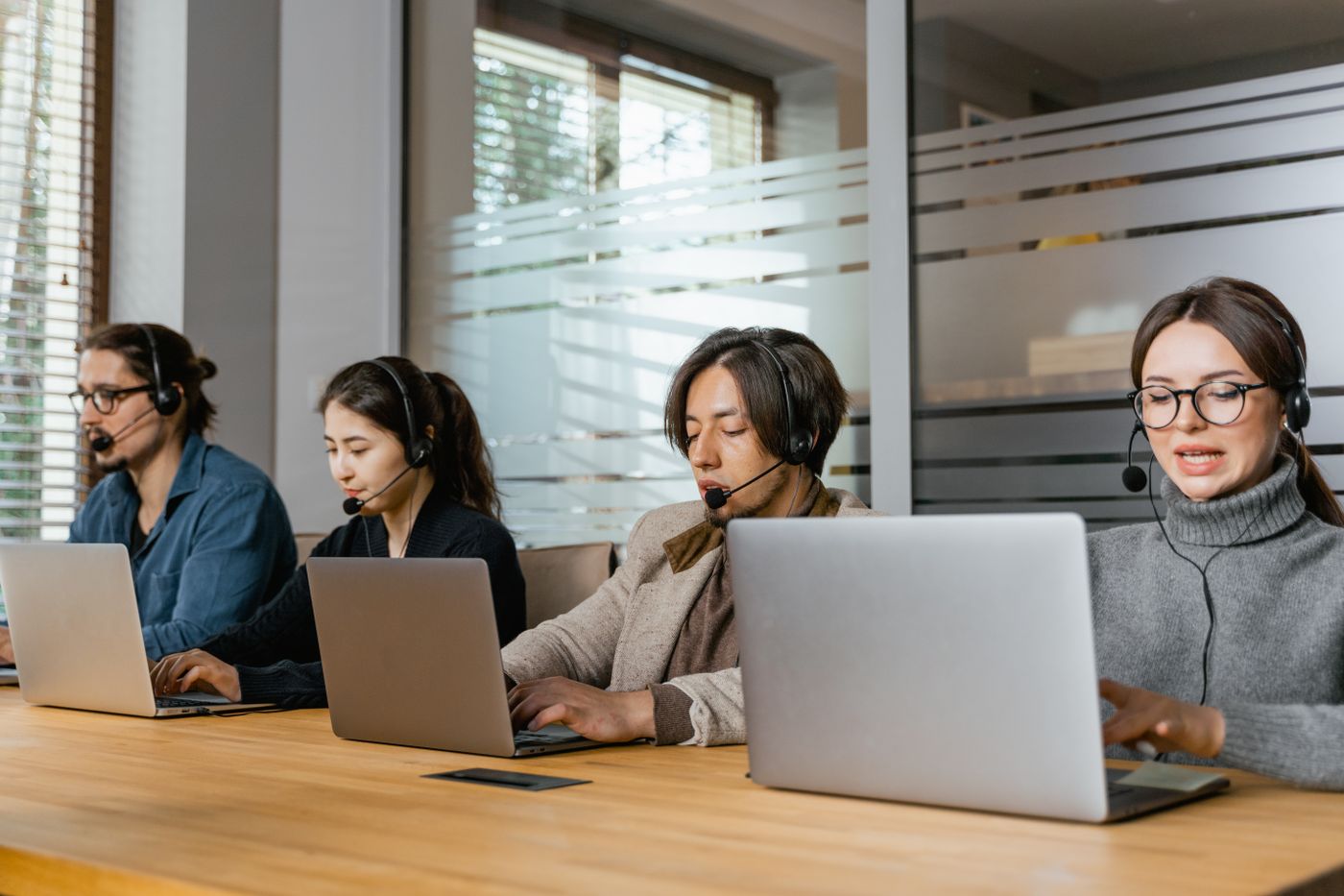 Sales reps working automated follow-ups on their laptops