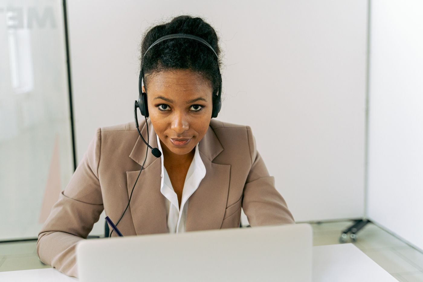 Apollo sales engagement, shown as a rep on a headset following up with prospects
