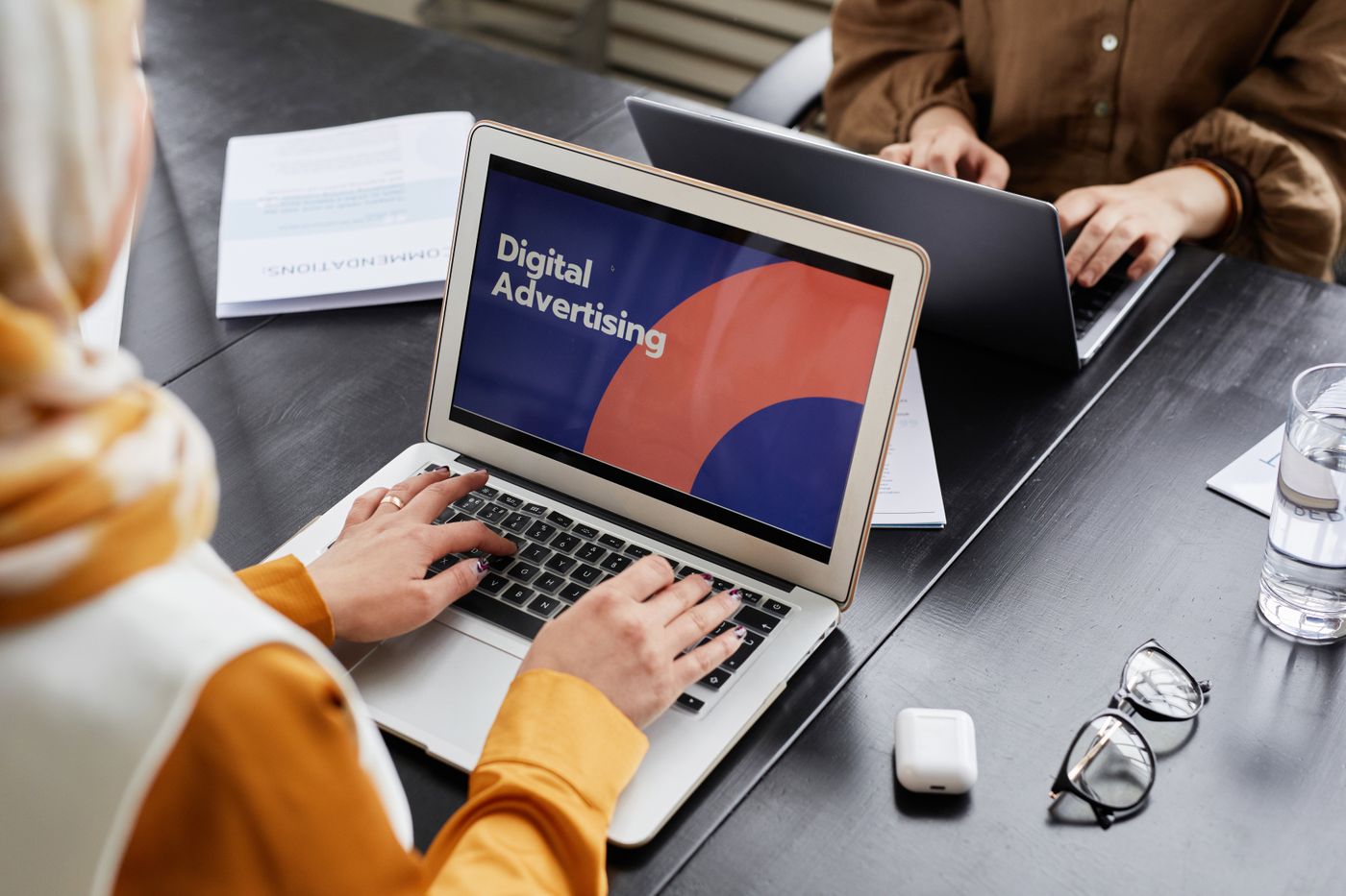 Marketer building a search ad campaign on her laptop