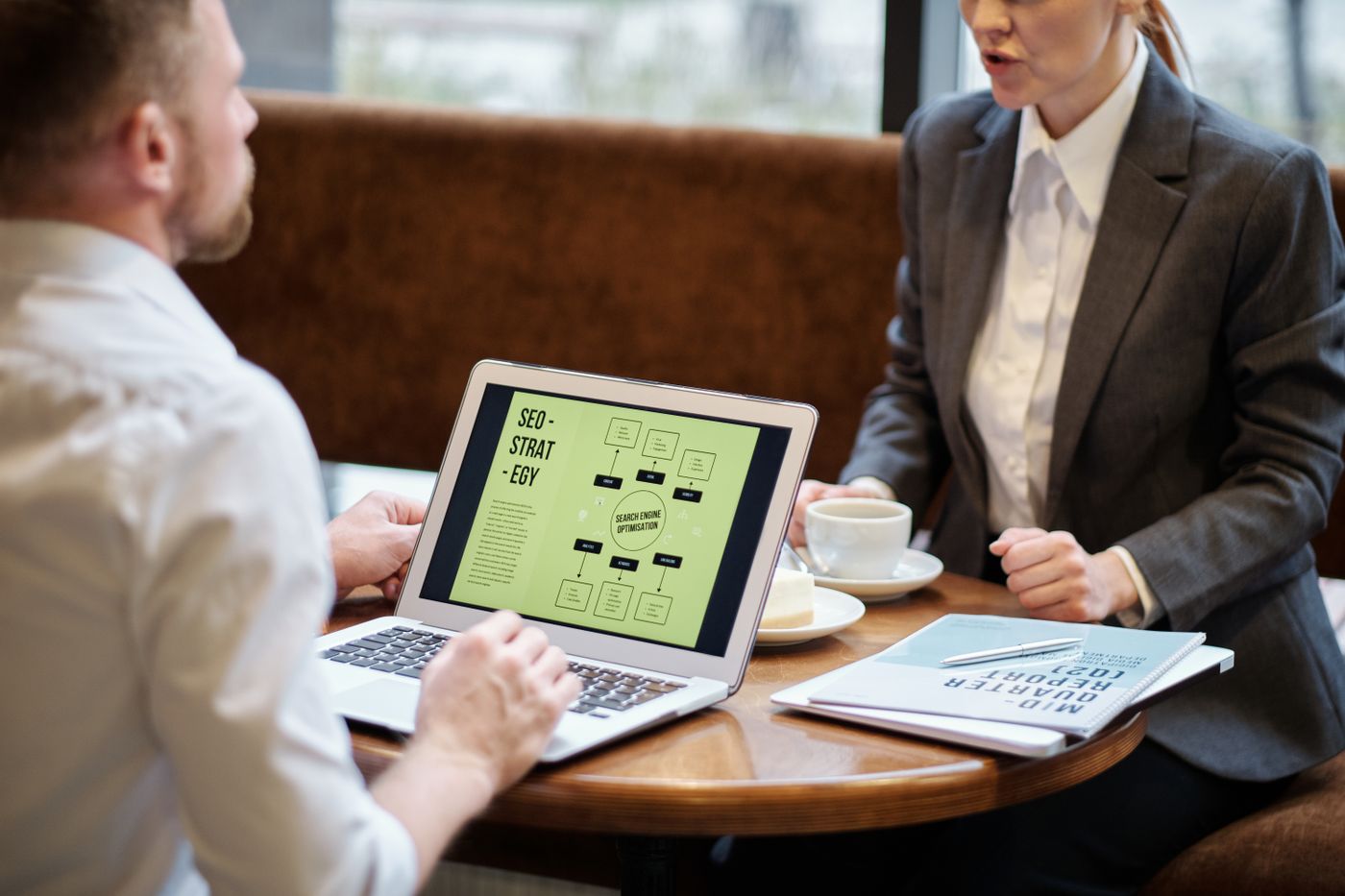 Two marketers planning a search strategy over a laptop