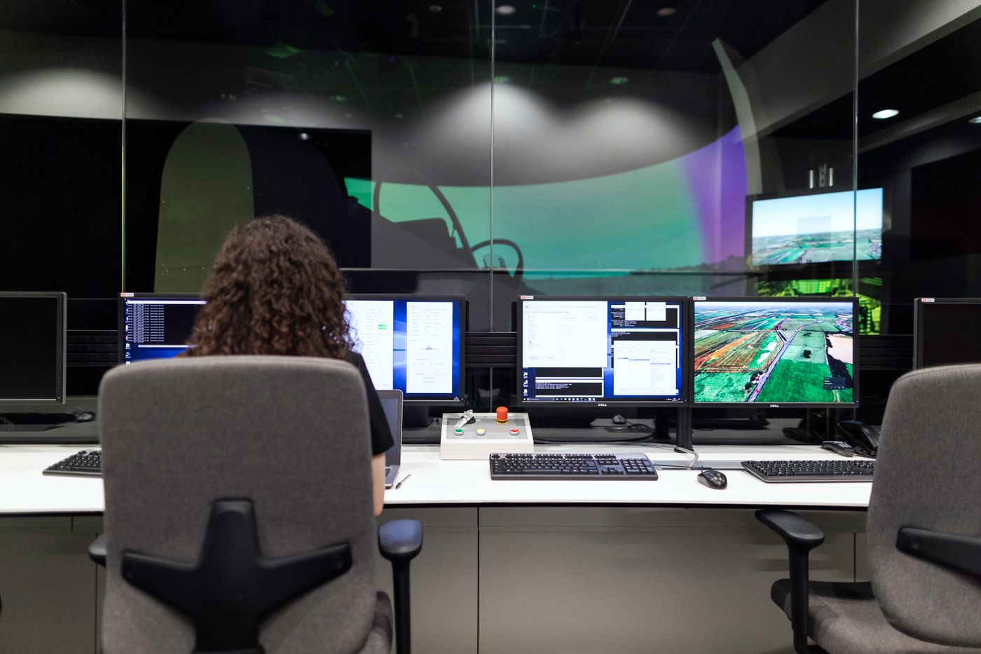 Engineer monitoring workflows across multiple screens