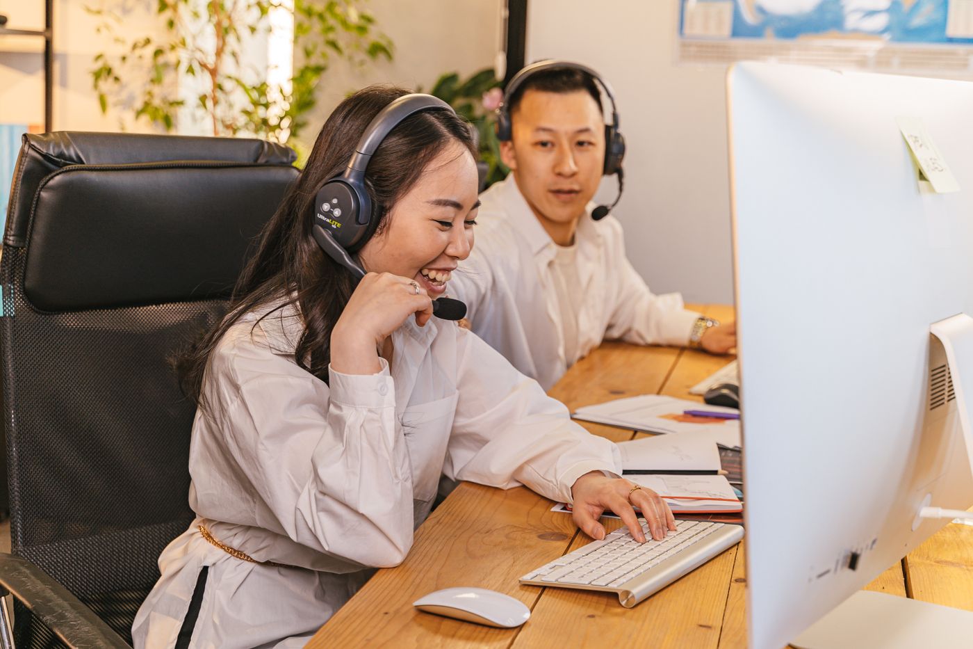 Support specialists monitoring automations with headsets
