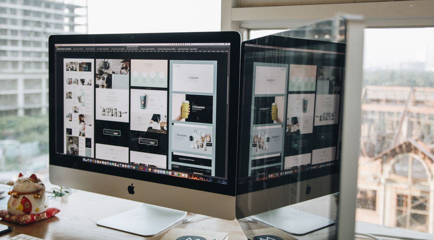Two monitors showing landing page variants side by side