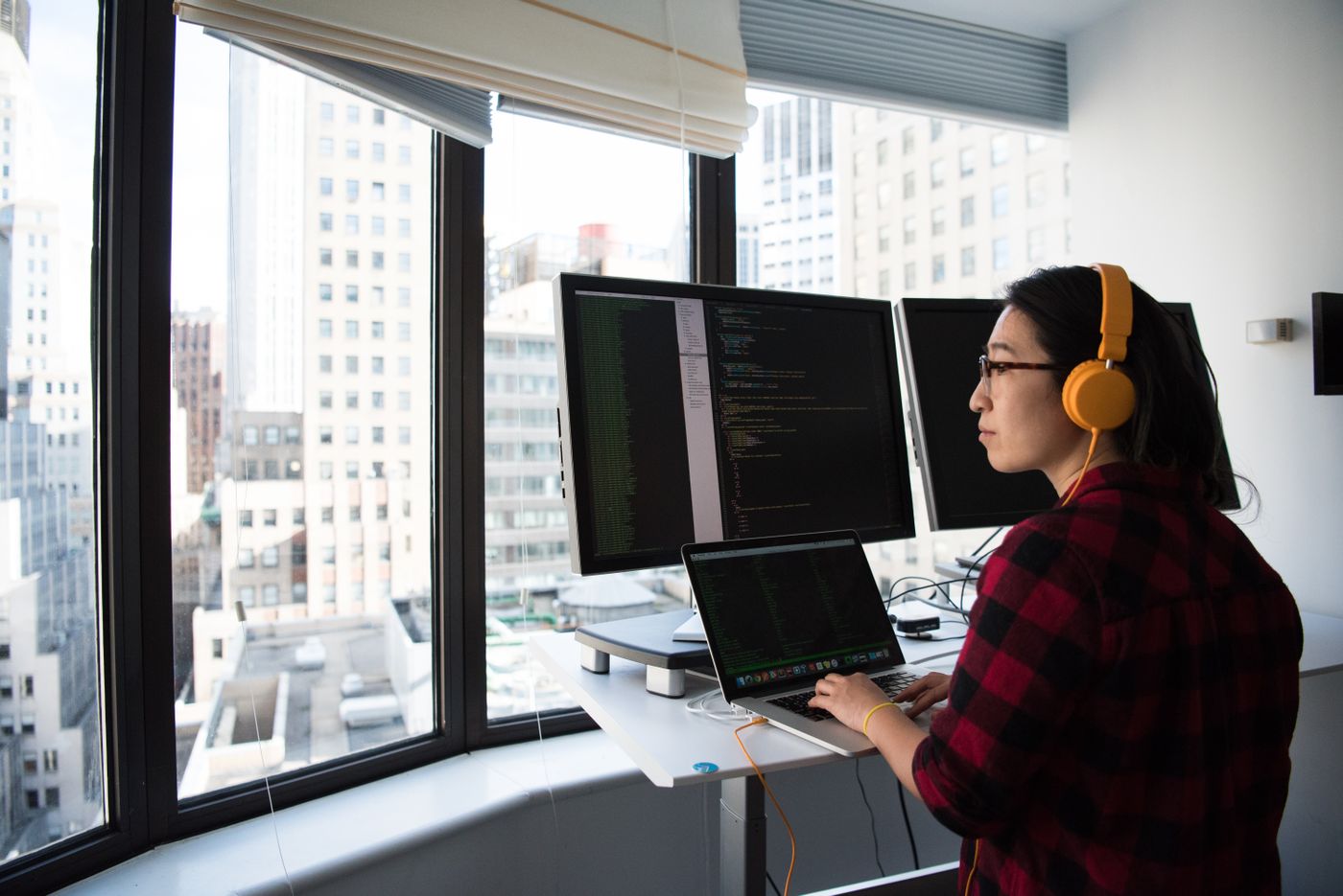 Developer building n8n workflows at a standing desk