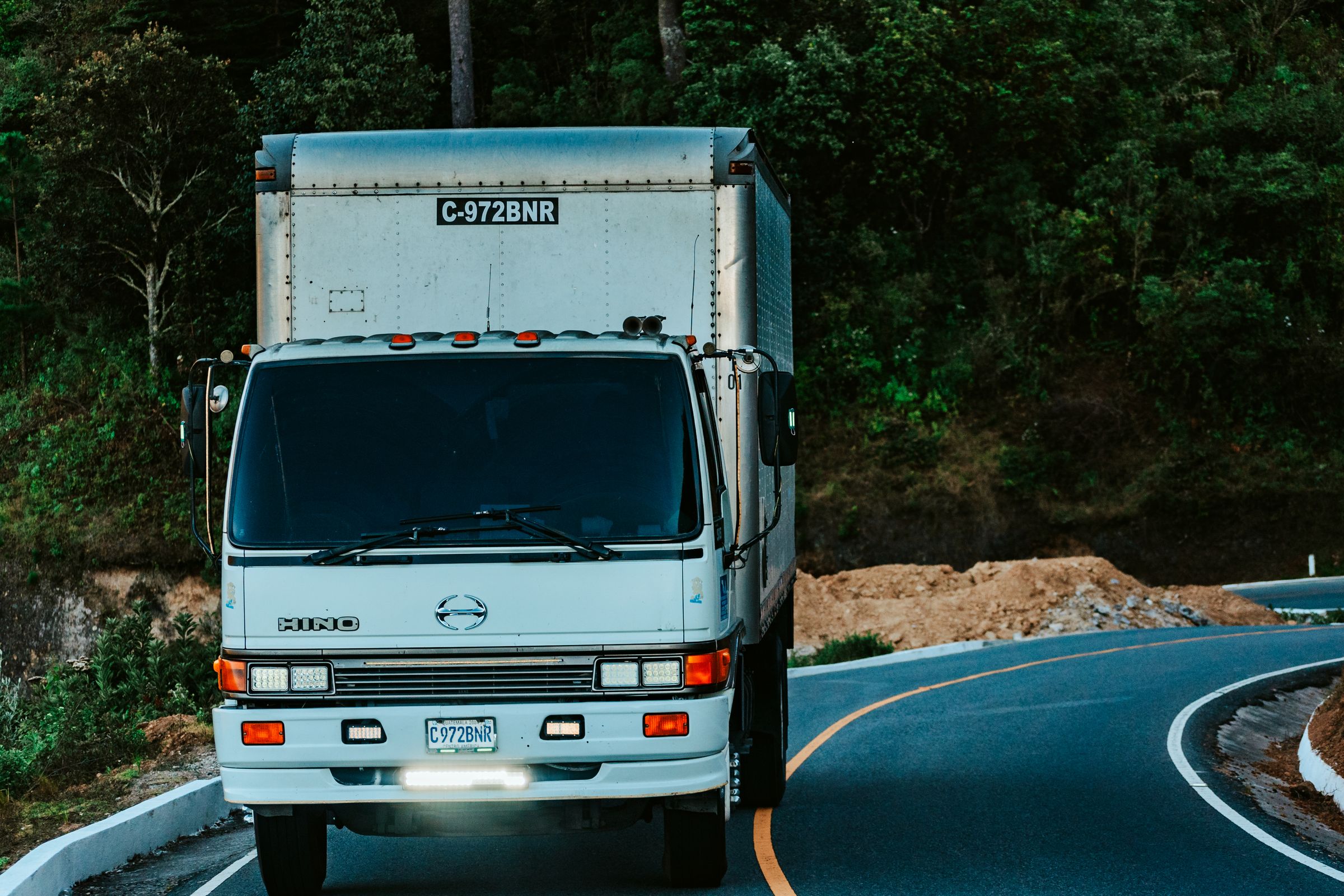 Delivery truck driving along a winding road
