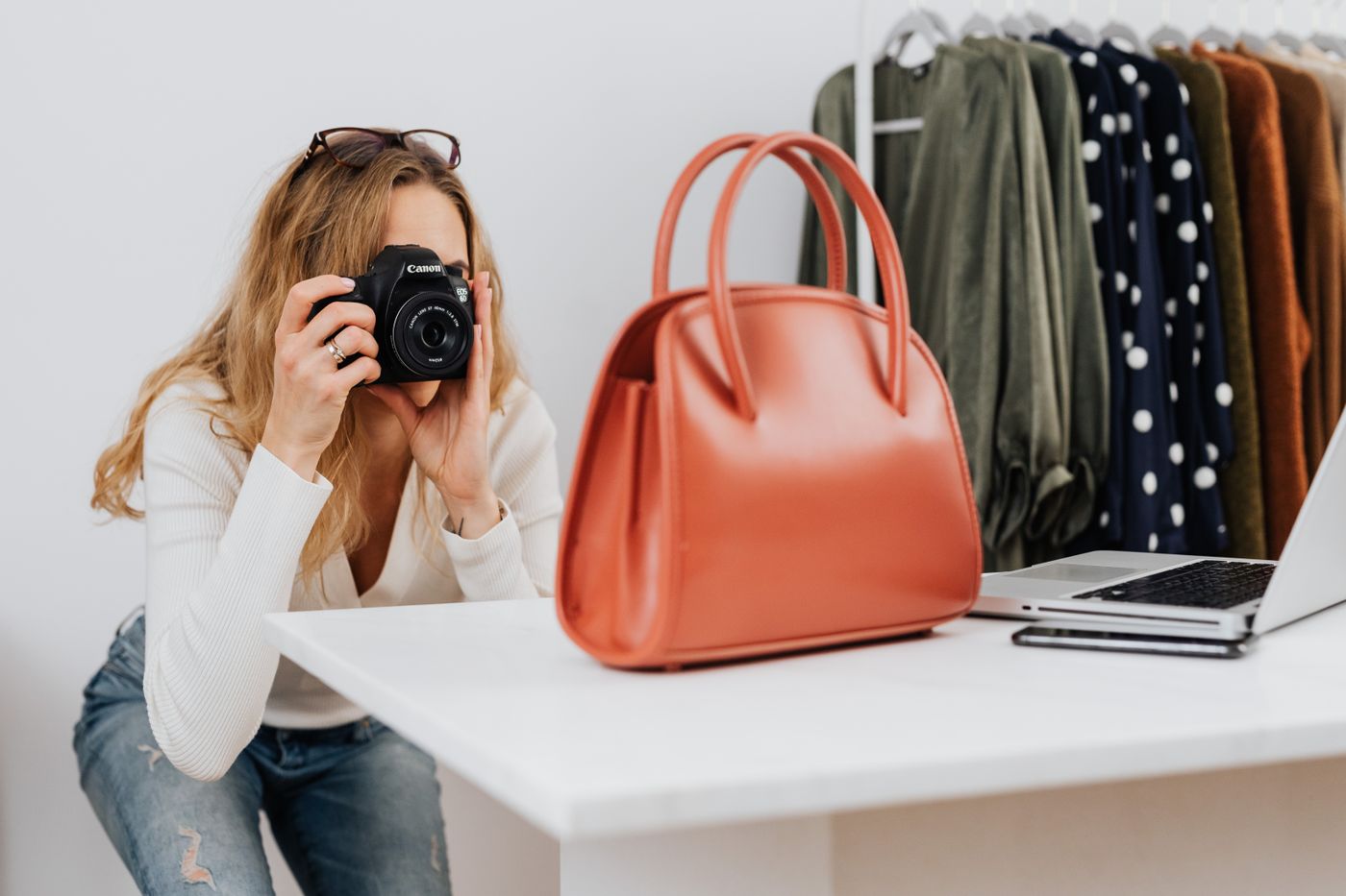Brand owner photographing a handbag for an online store