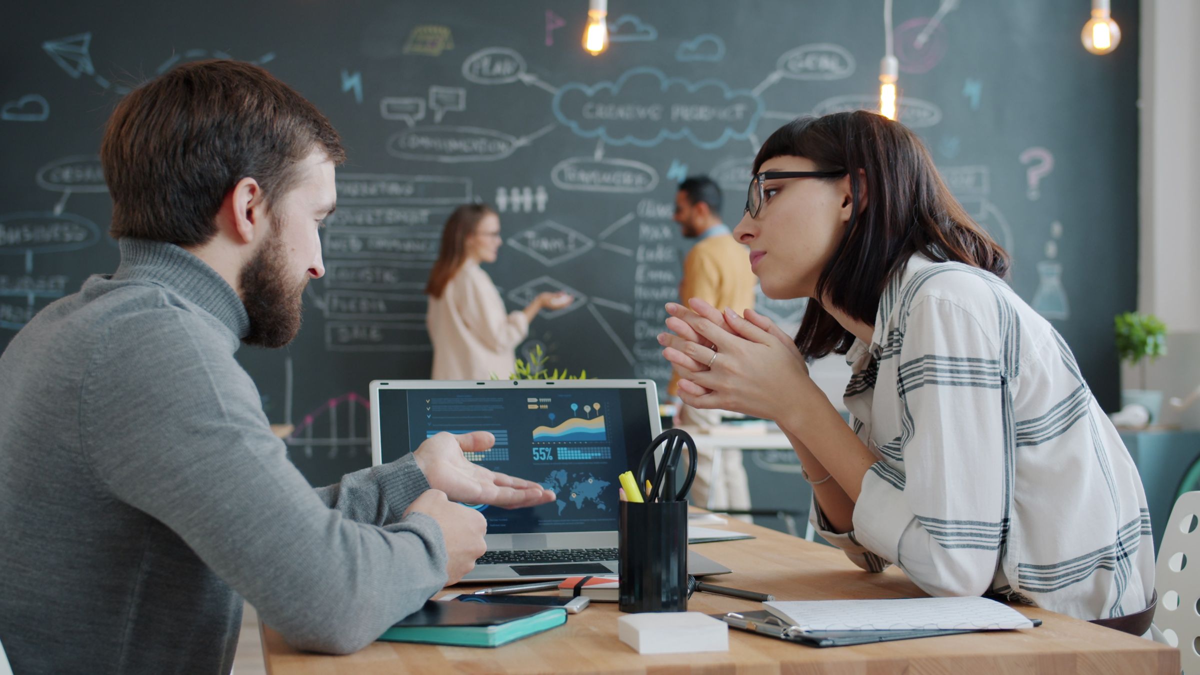 Engineers working through a system design at a screen