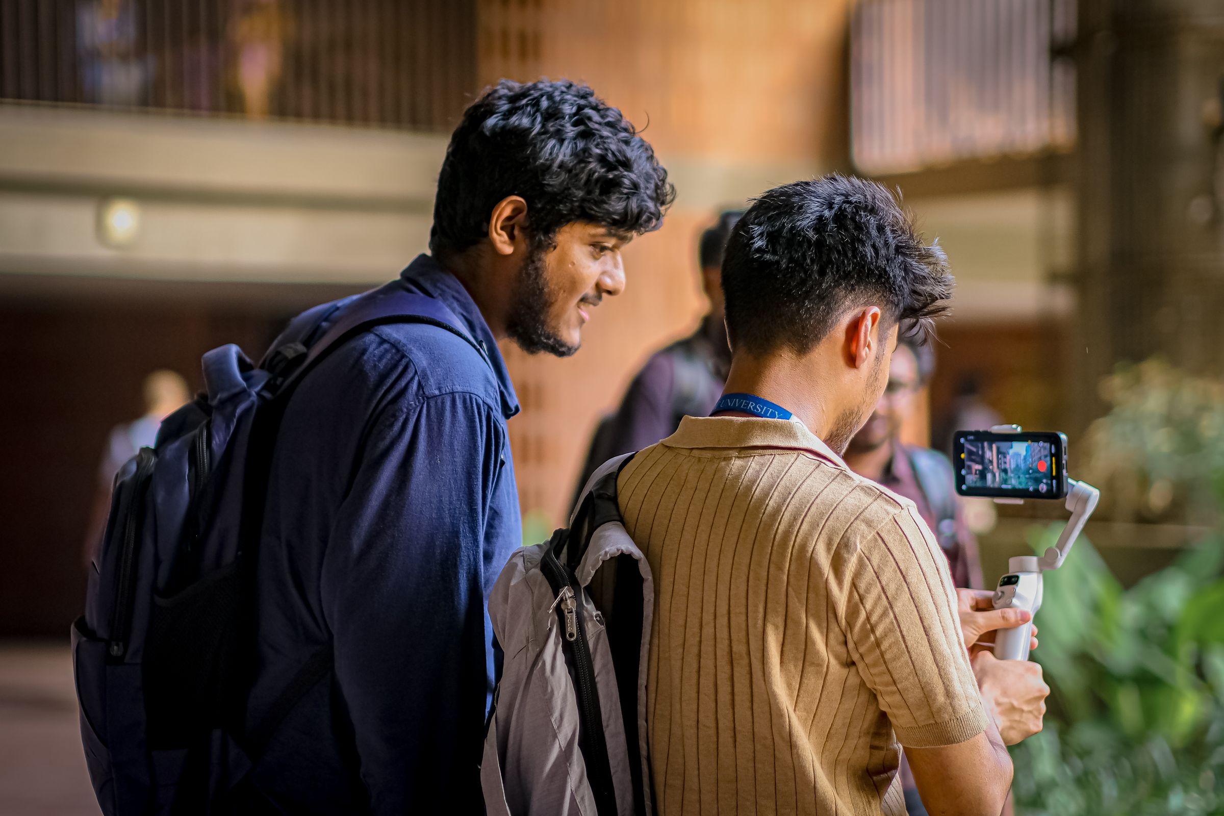 Students filming employer brand content on a university campus