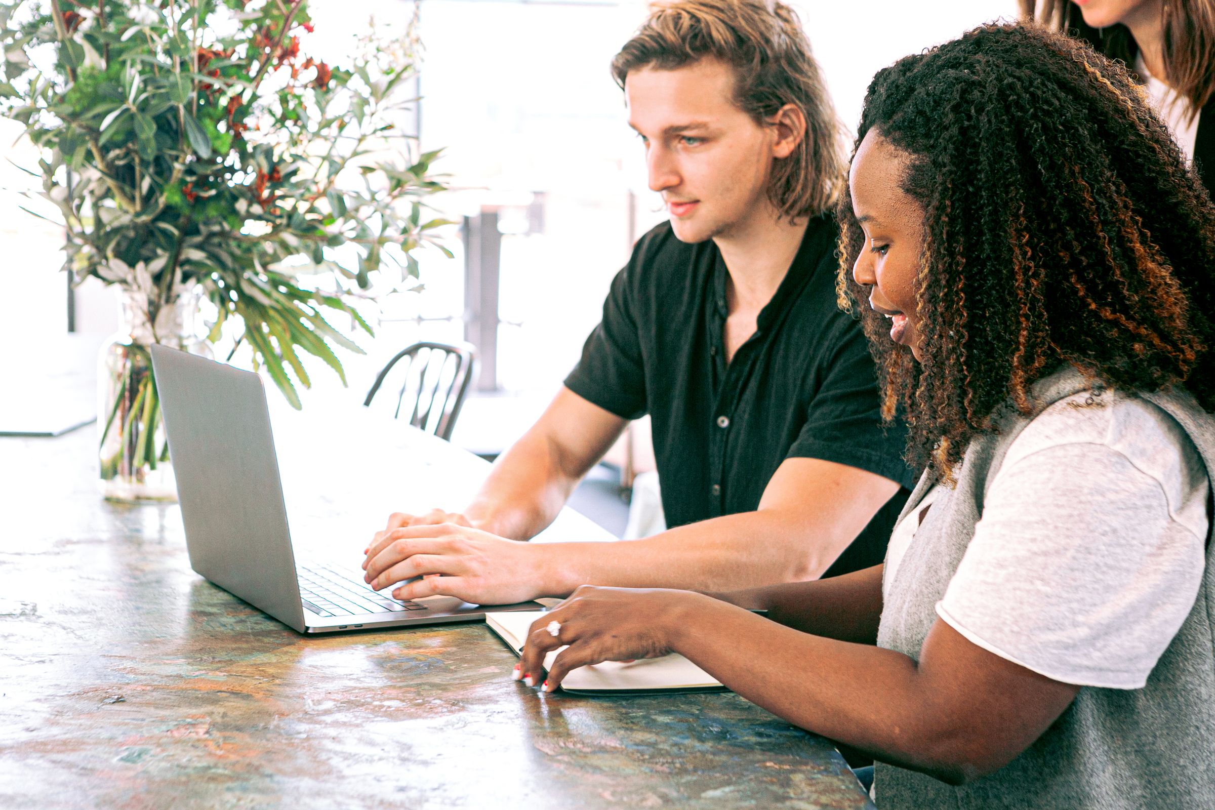 Two marketing colleagues working together at a laptop