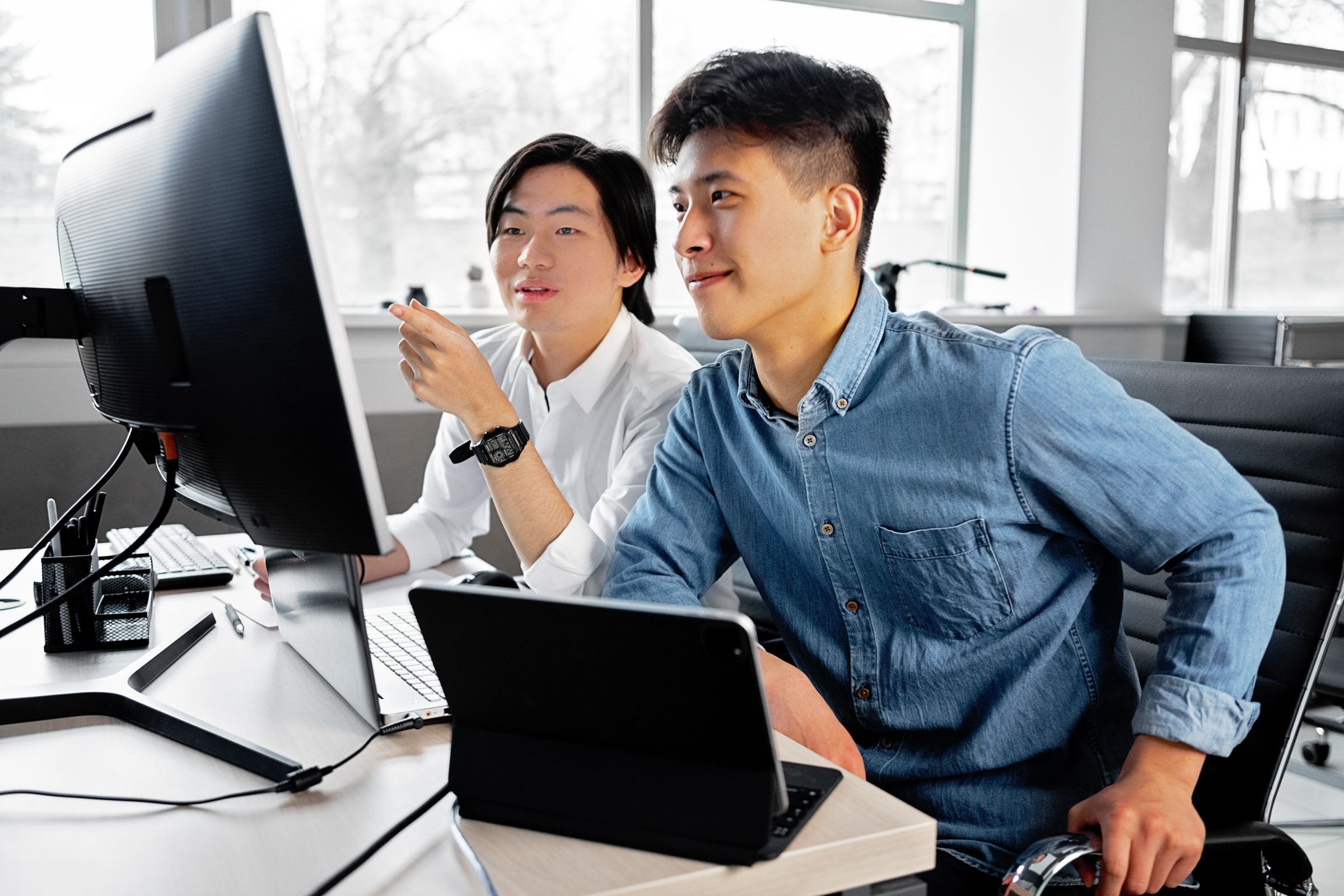 Two engineers reviewing an integration workflow together at a screen